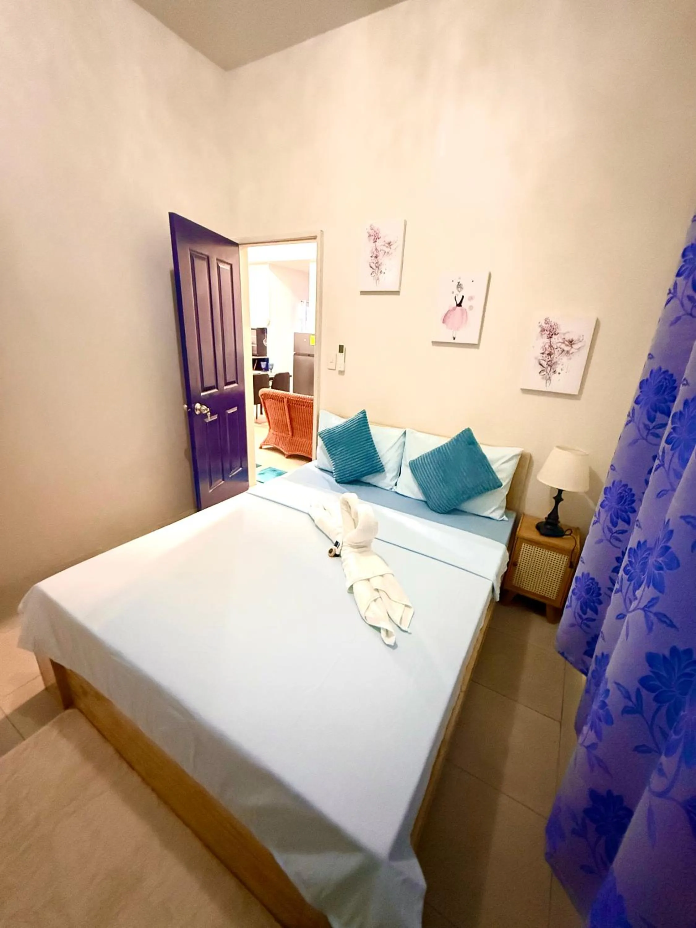 Bed in Blue Summer Suites & Restaurant