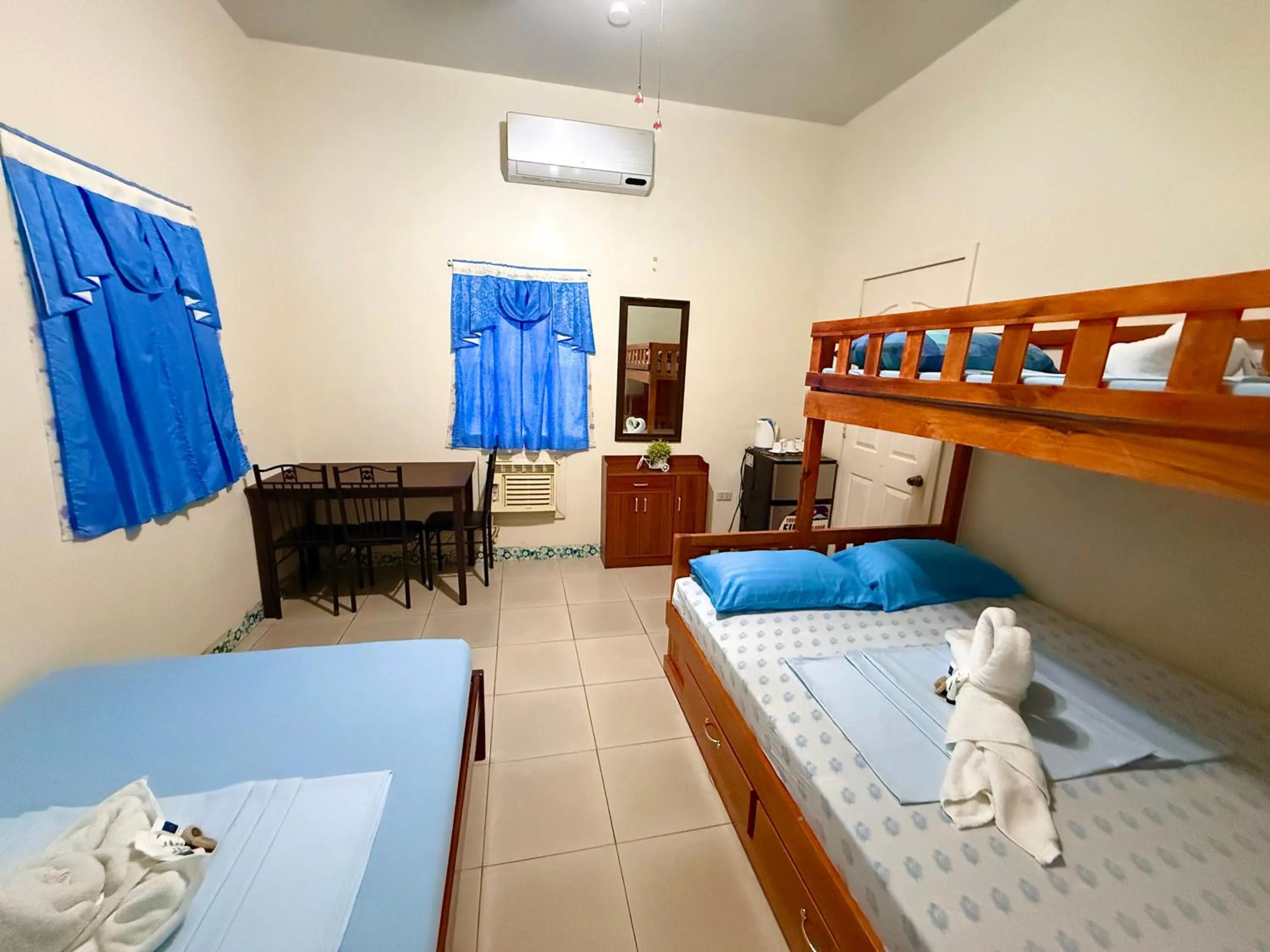 Bed in Blue Summer Suites & Restaurant