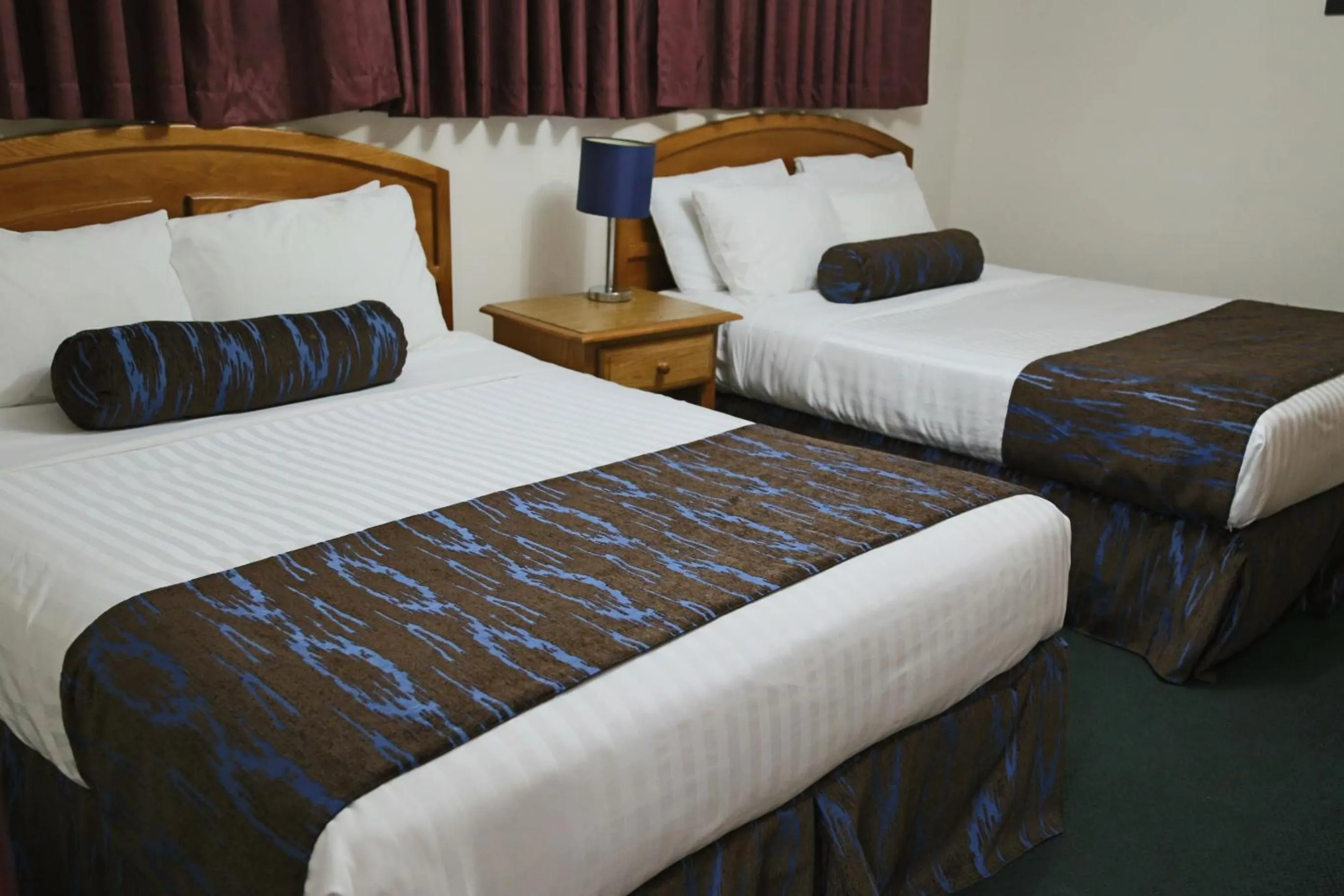 Bed in SlumberLodge Hotel