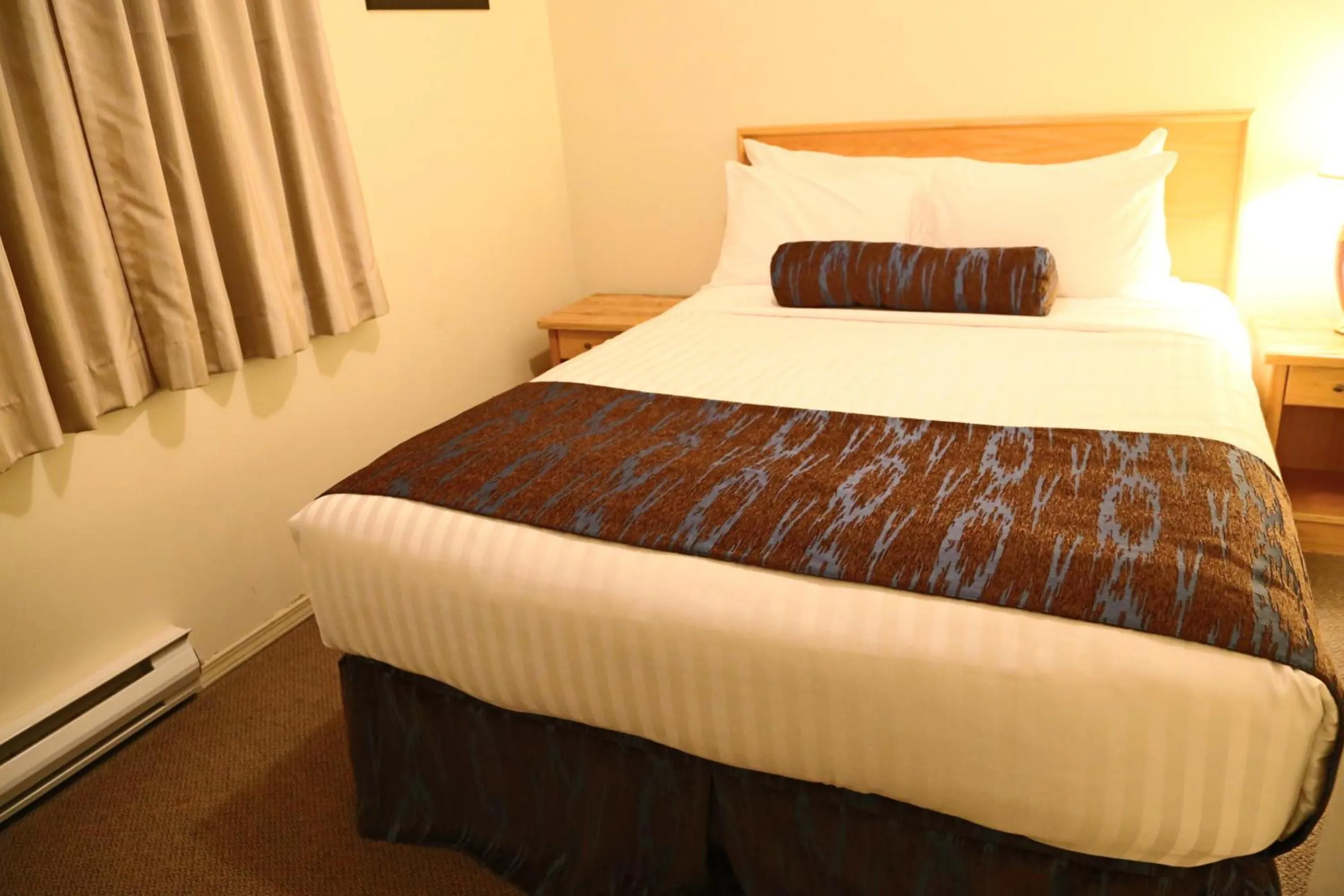 Bed in SlumberLodge Hotel