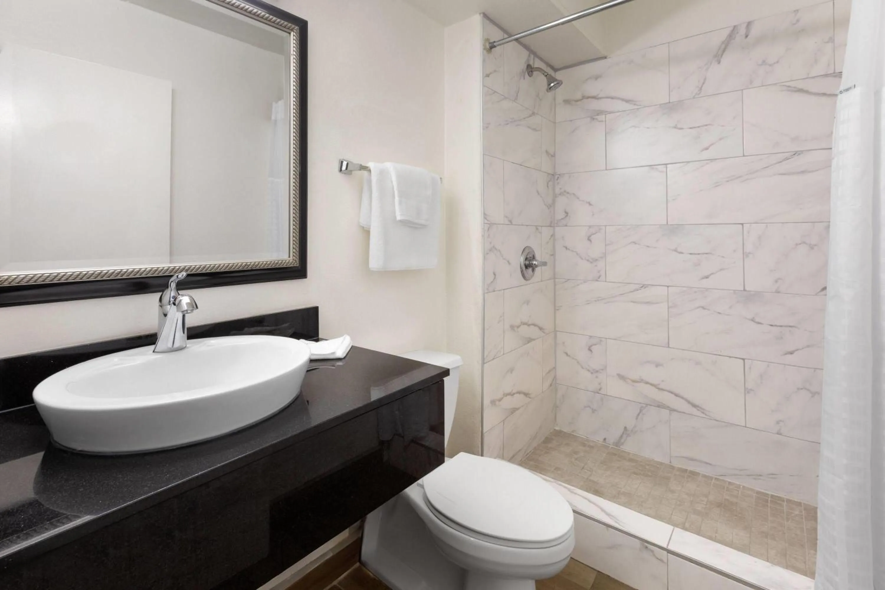 Bathroom in Travelodge by Wyndham Madison Heights MI