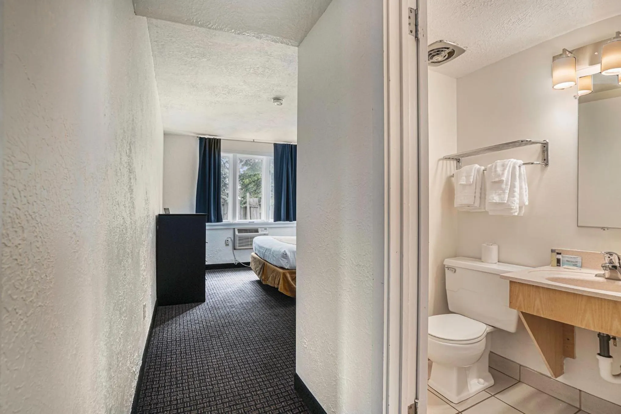 Bathroom, Bed in Travelodge by Wyndham Traverse City MI