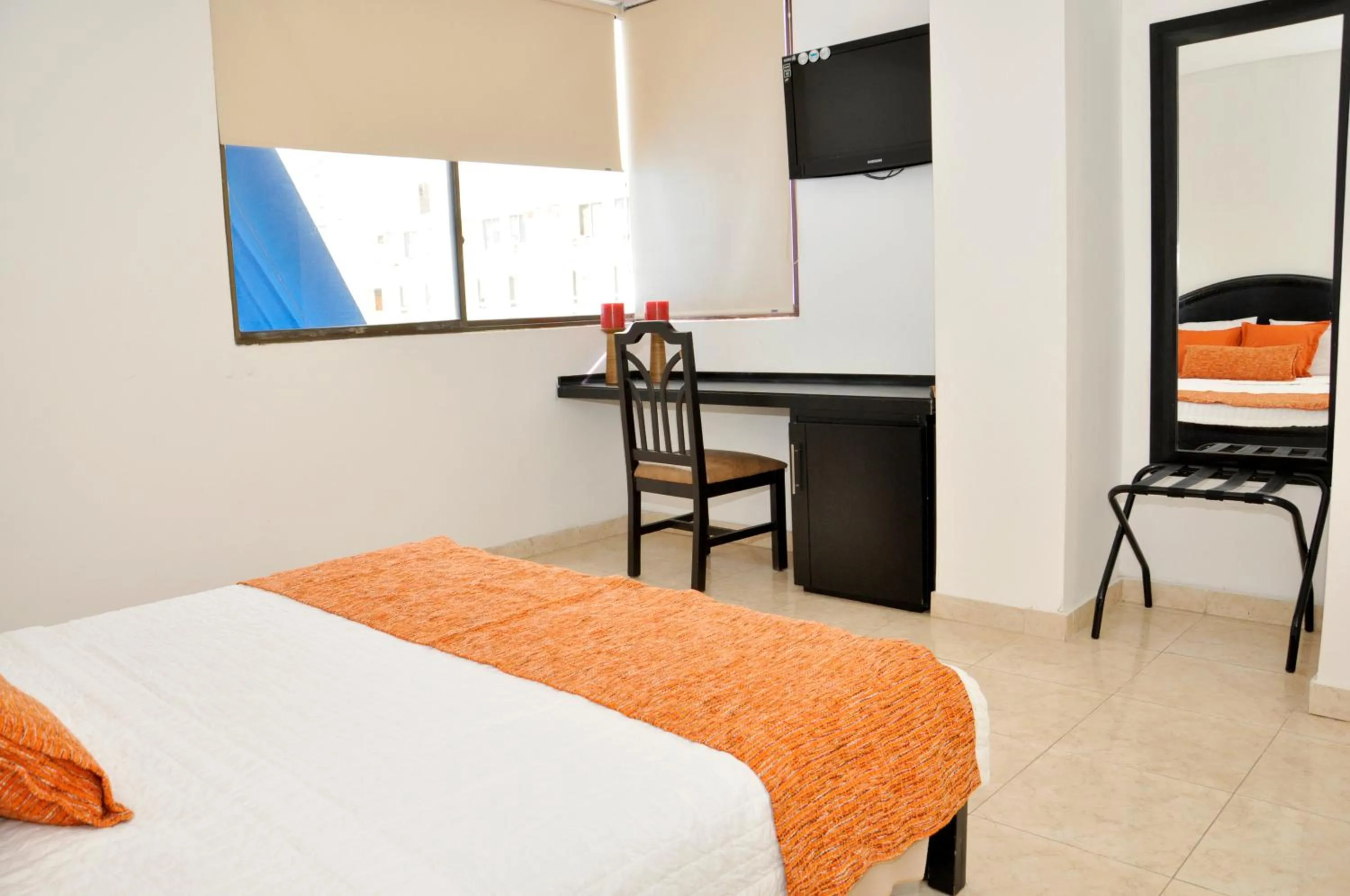 Communal lounge/ TV room, Bed in Hotel Axis Inn By GEH Suites