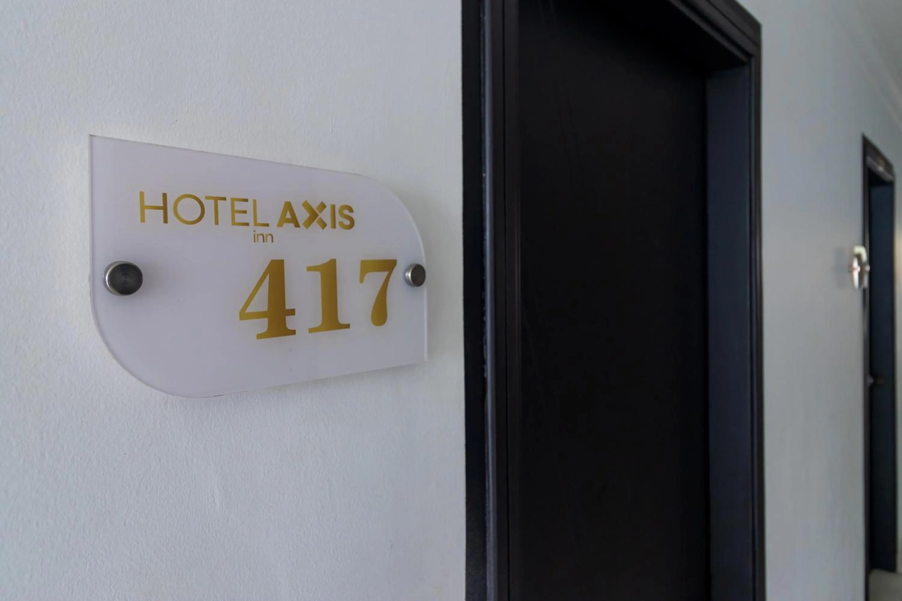 Property building in Hotel Axis Inn By GEH Suites