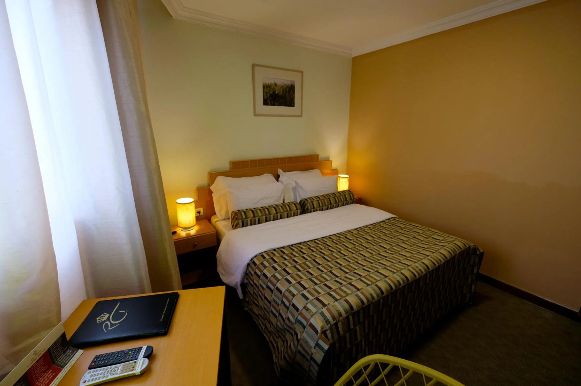 Bed in Royal Court Hotel