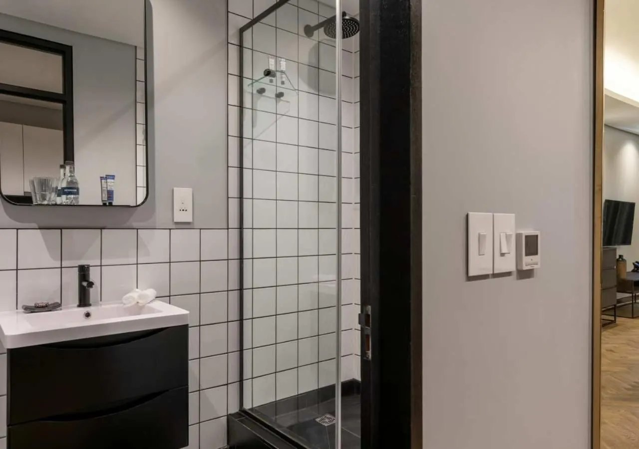 Shower in The Onyx Apartment Hotel by NEWMARK