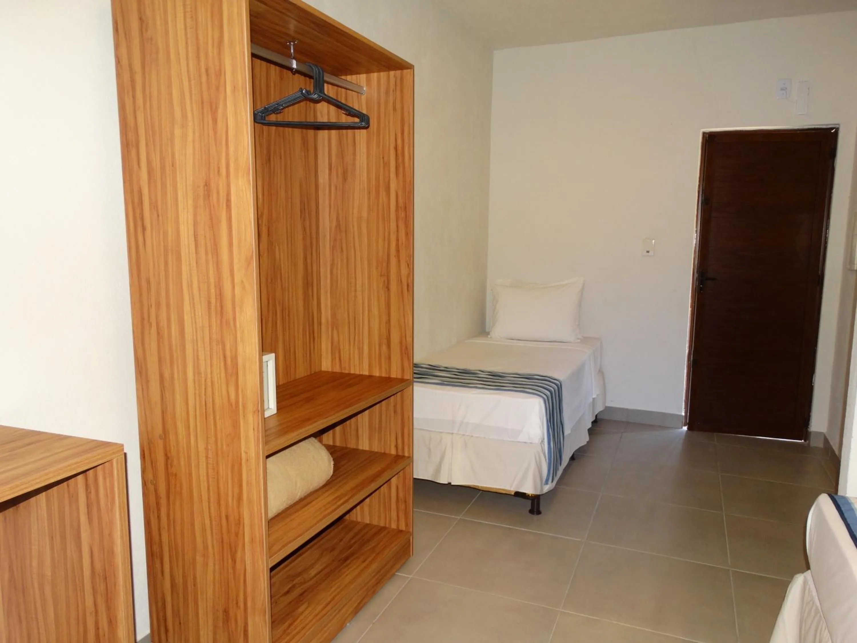 Bed in Pousada Tropicarim