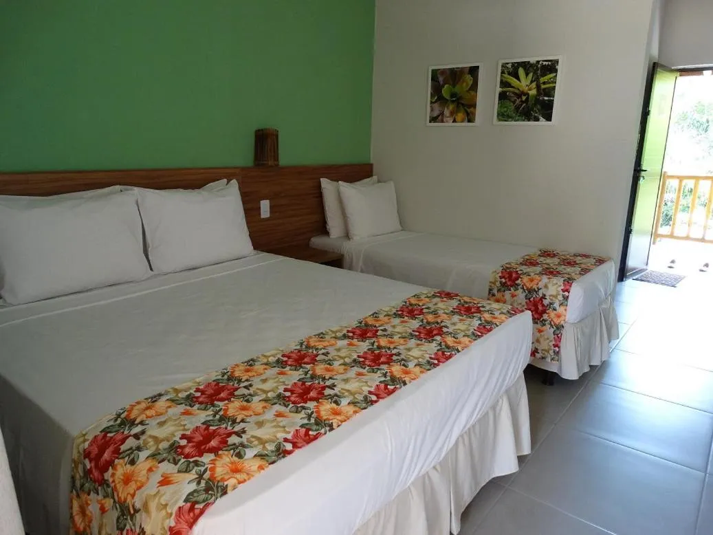 Bed in Pousada Tropicarim