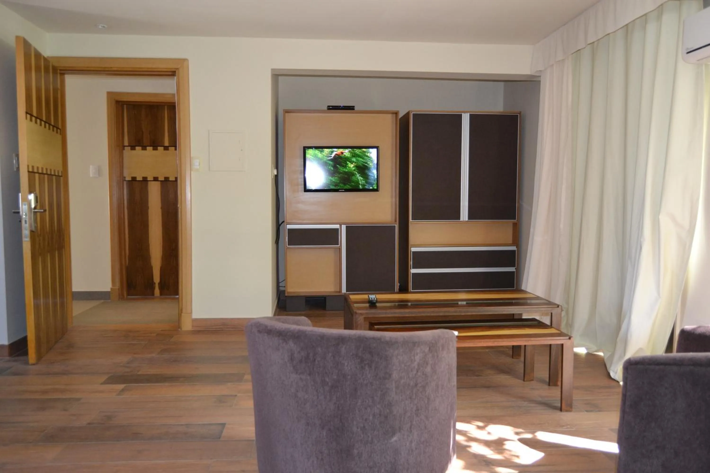 Communal lounge/ TV room in Plaza Paradiso Petit Hotel