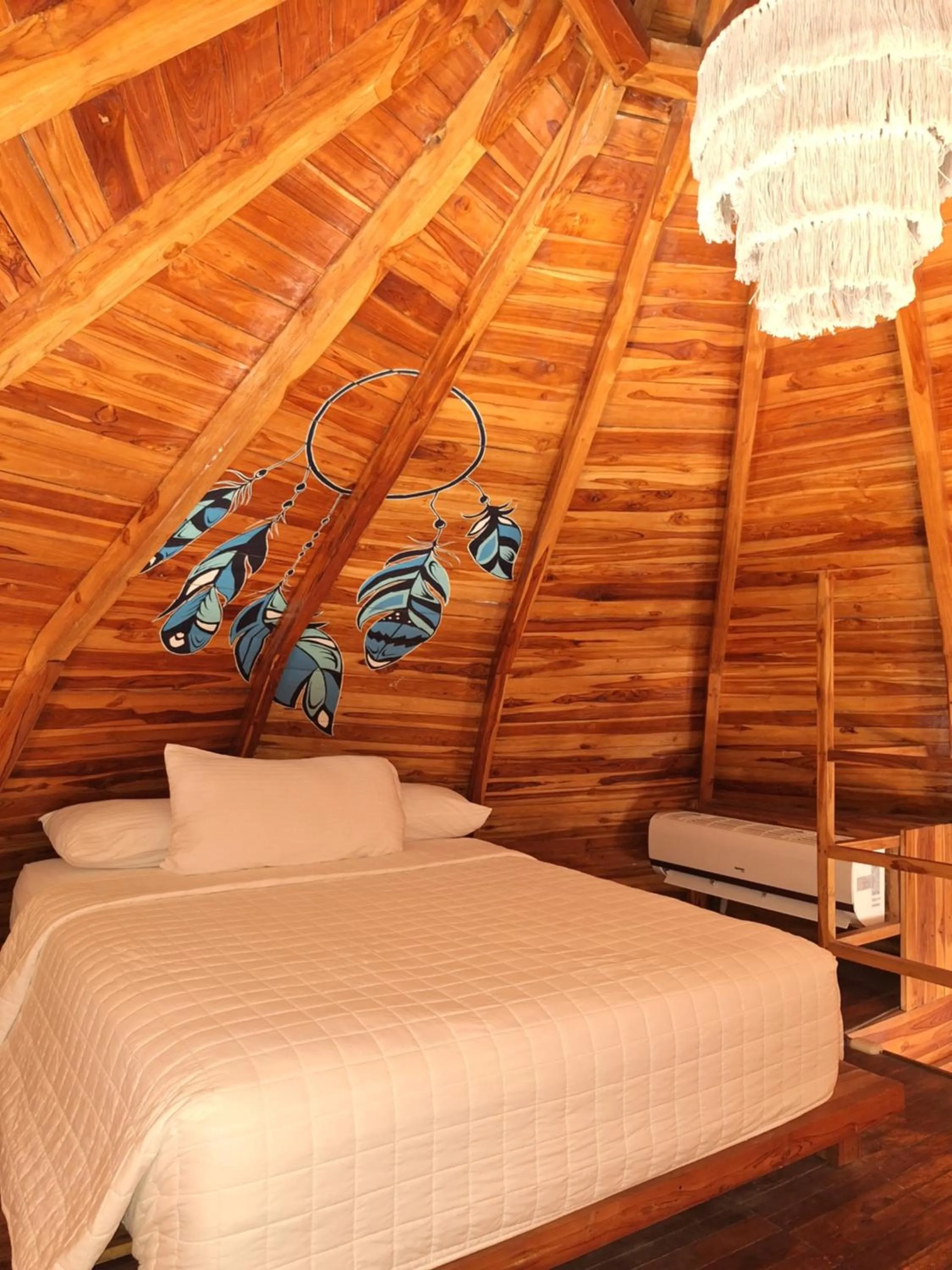 Bed in Hotel Tortuga Village