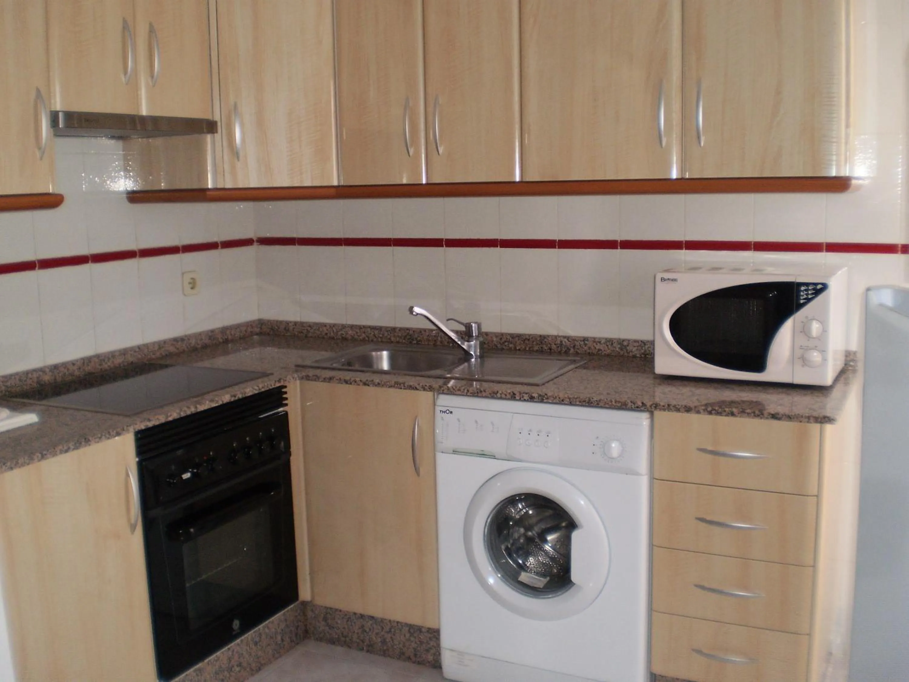 Kitchen or kitchenette in Apartamentos Copacabana Playa