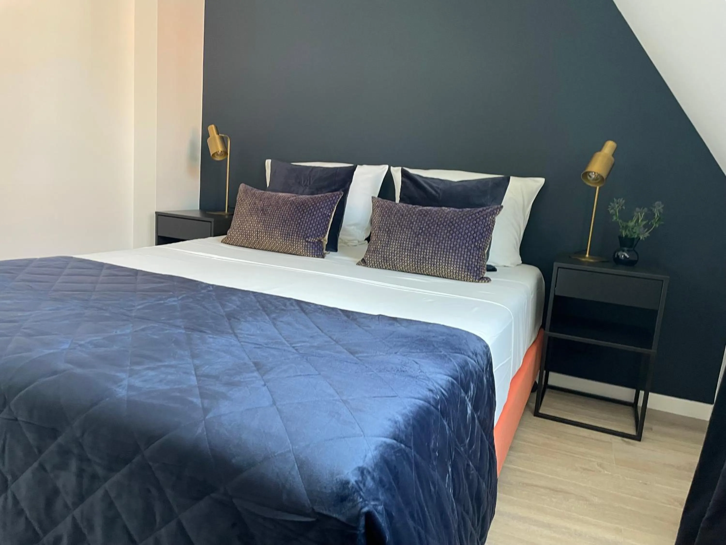 Bed in The Roosevelt Apartments