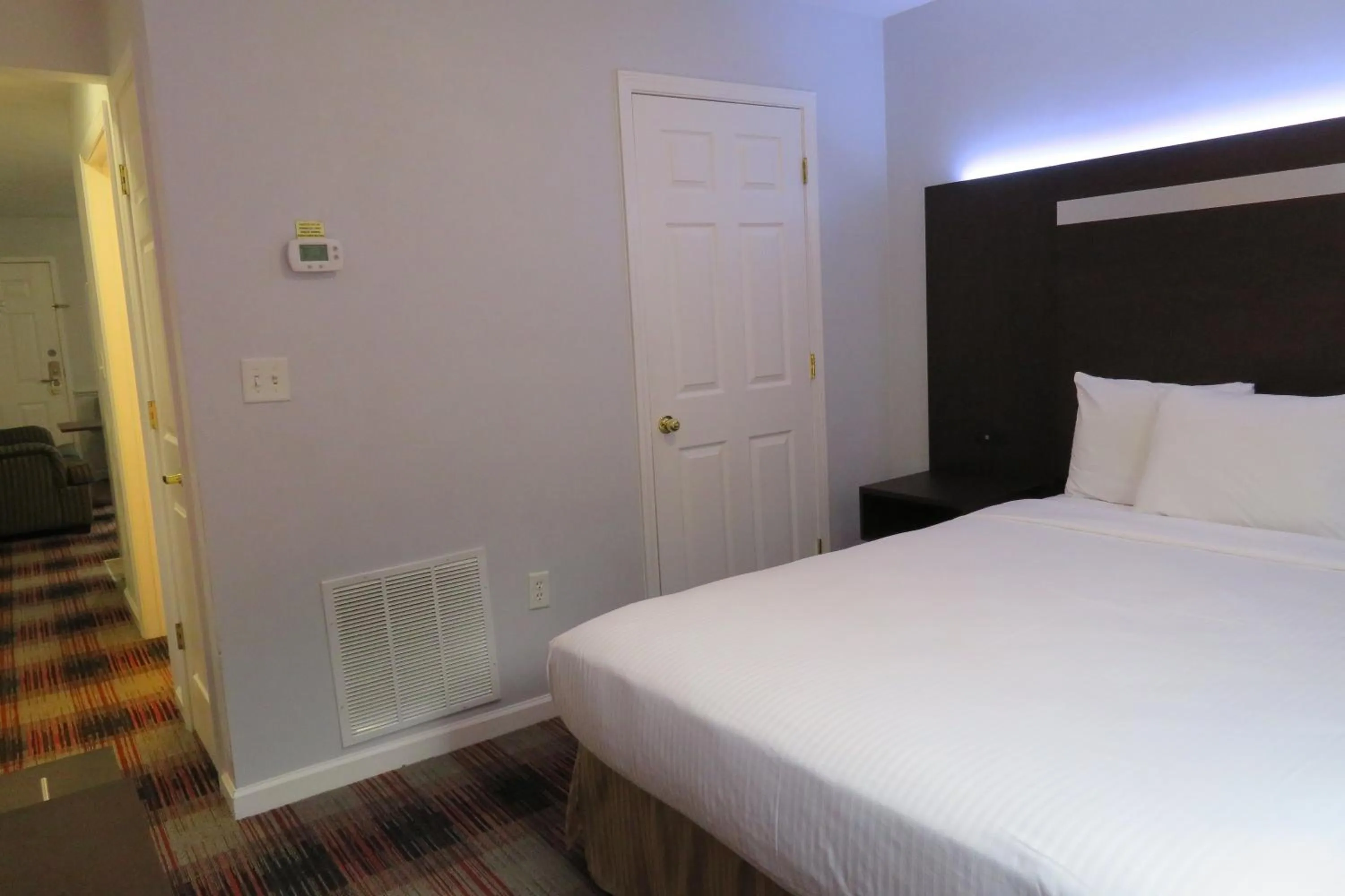 Bed in Luxbury Inn & Suites