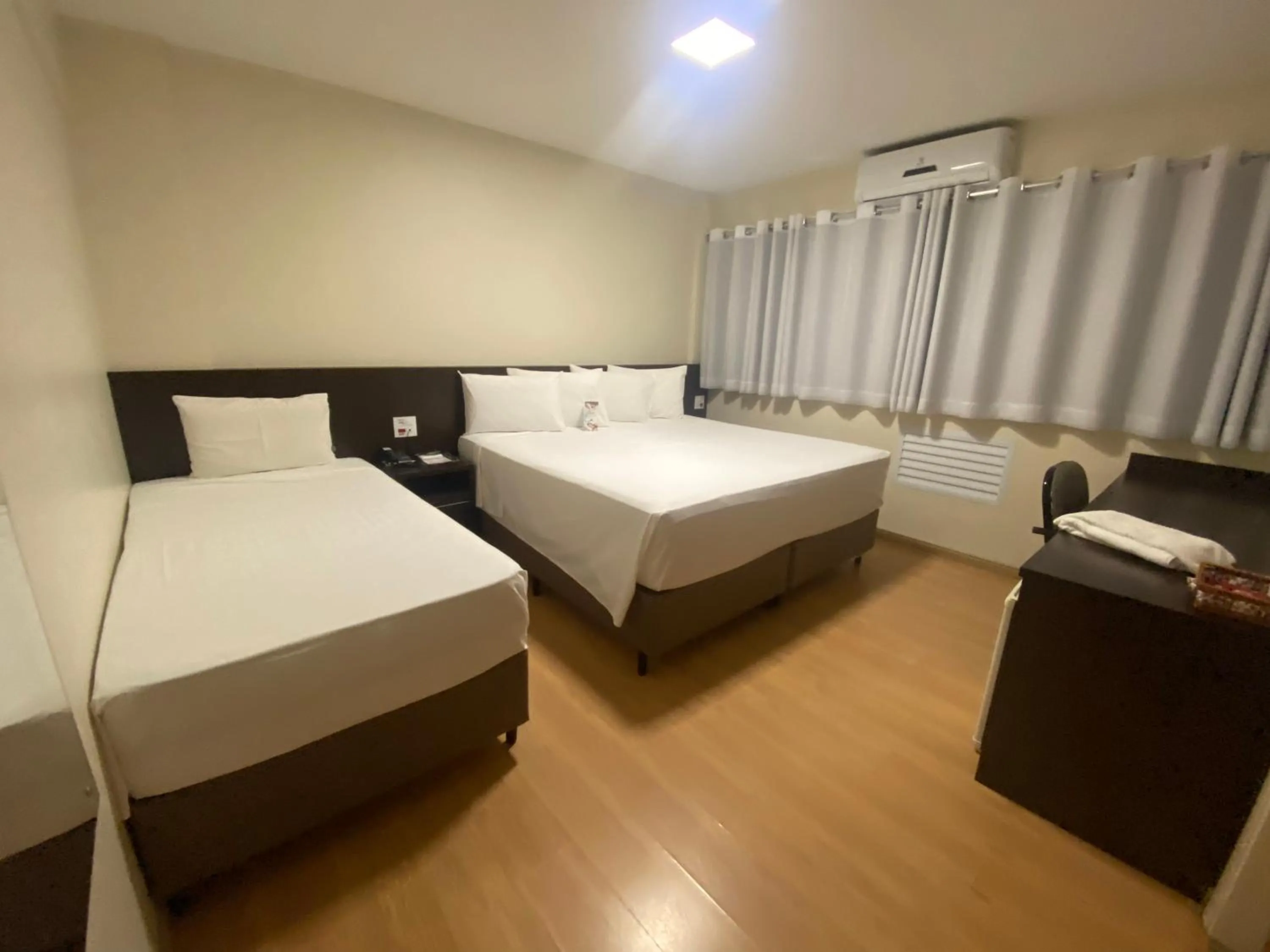 Bed in HD Plaza Hotel