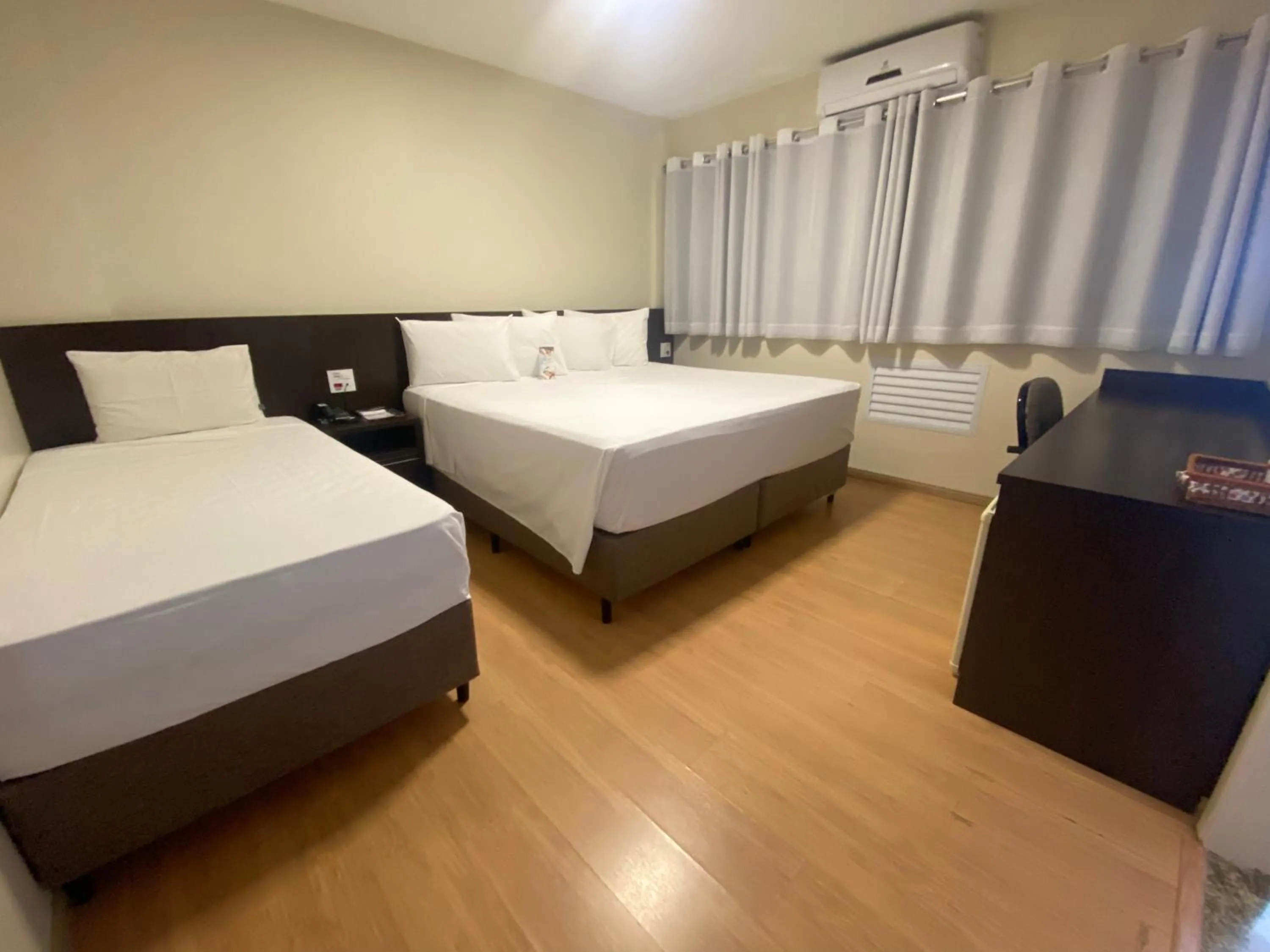 Bed in HD Plaza Hotel