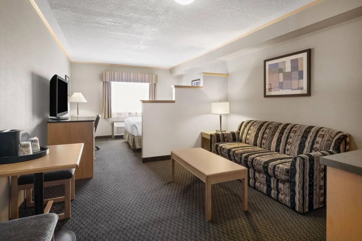 Seating area, Bed in Travelodge by Wyndham Fort McMurray