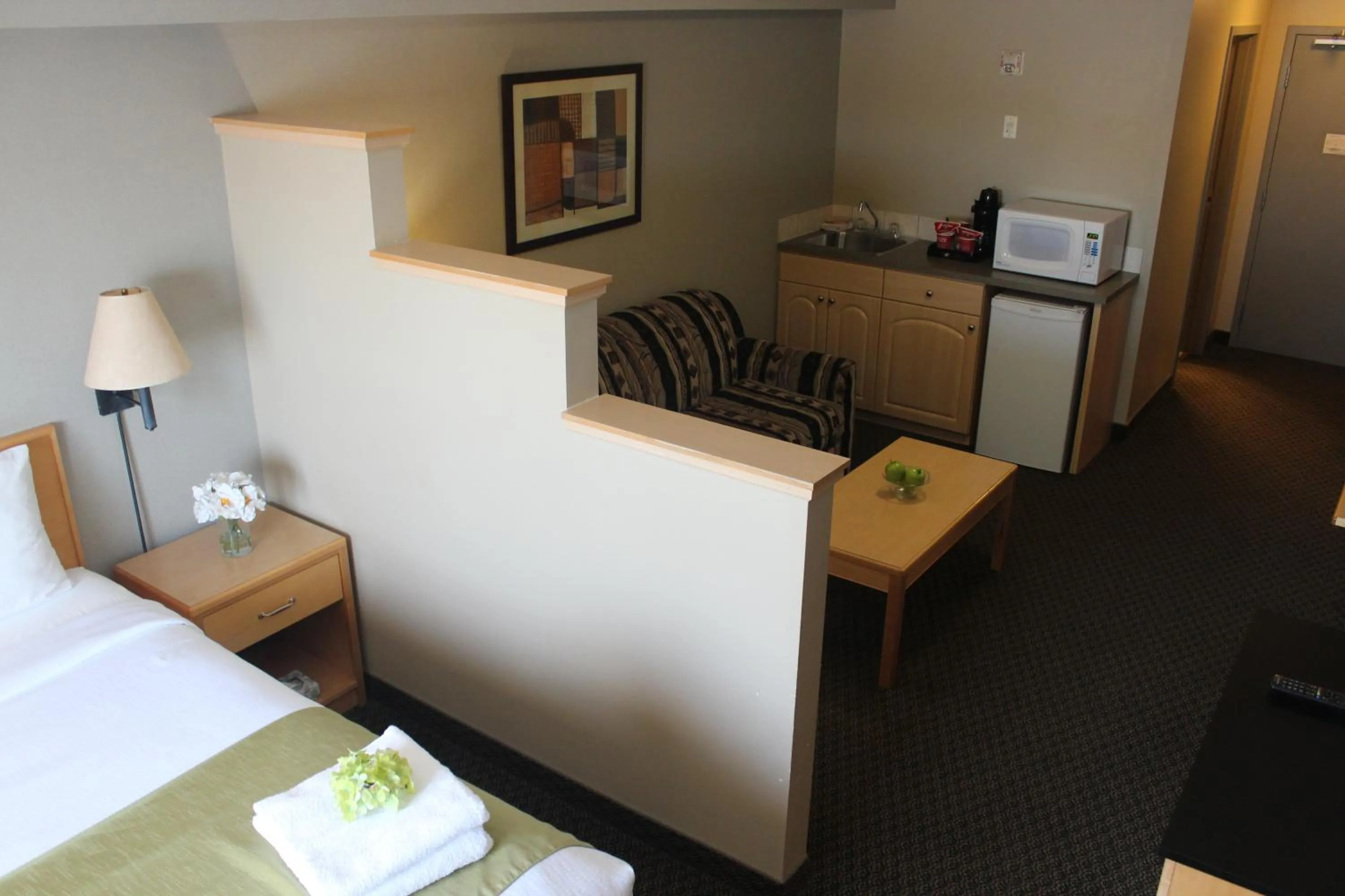 Seating area, Bed in Travelodge by Wyndham Fort McMurray