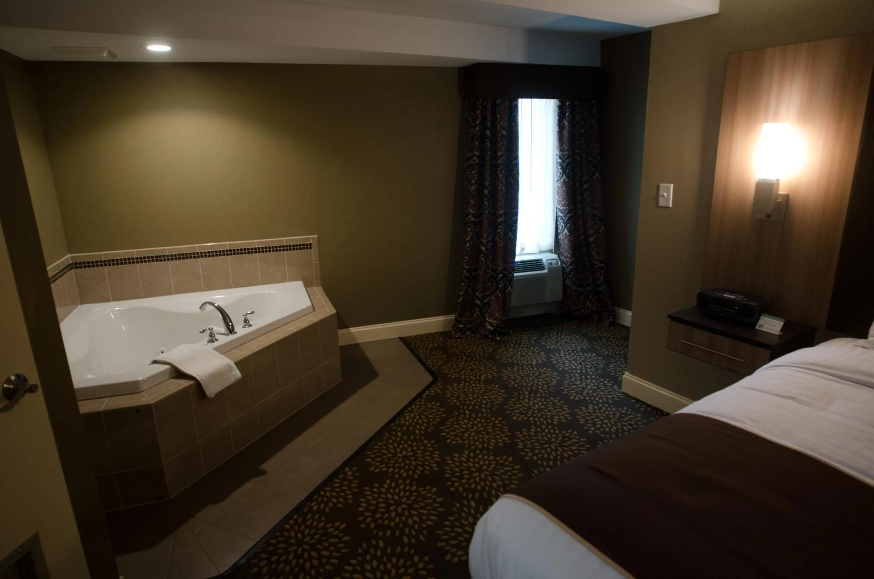 Photo of the whole room, Bed in Aashram Hotel by Niagara River