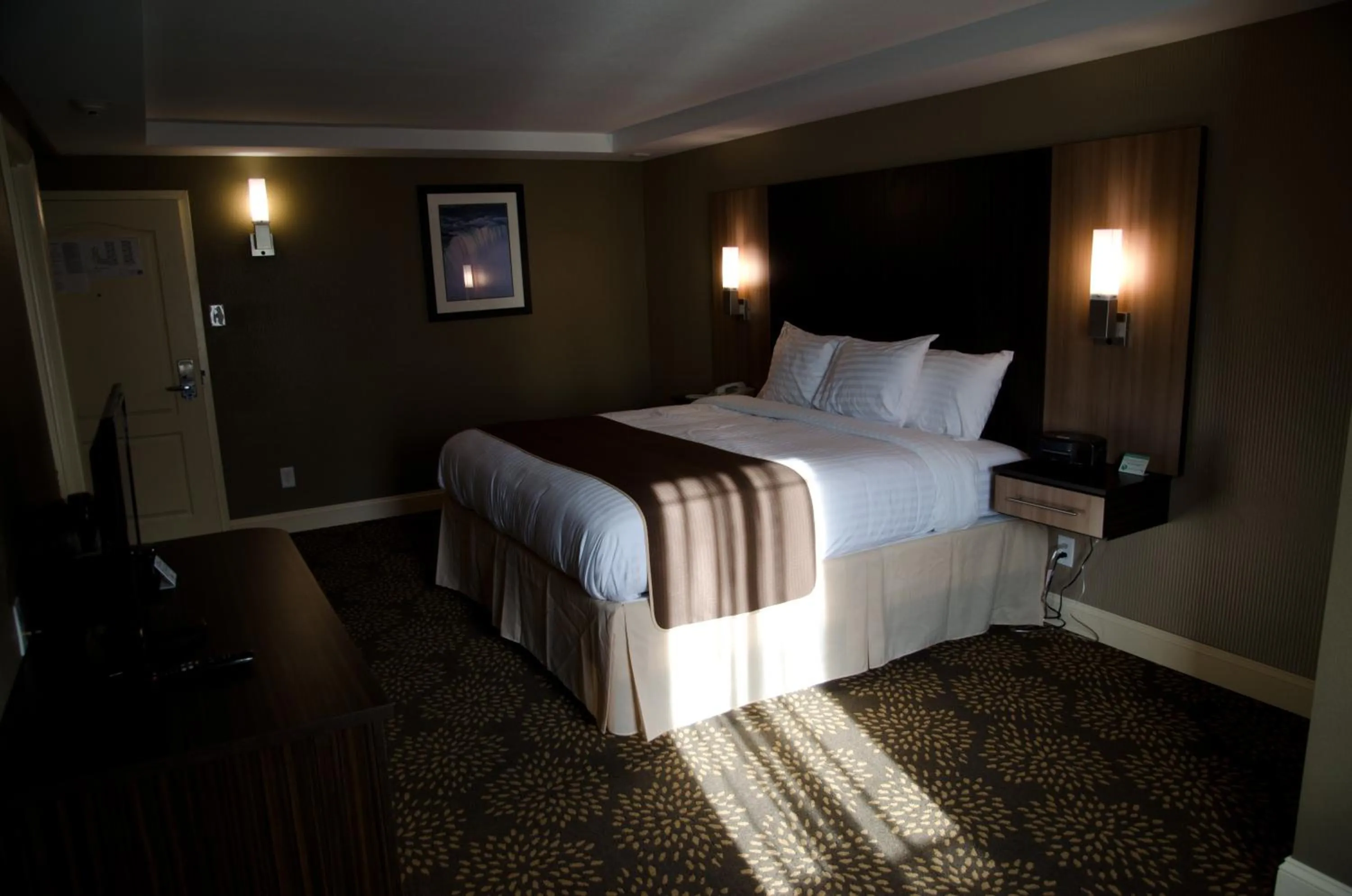 Photo of the whole room, Bed in Aashram Hotel by Niagara River