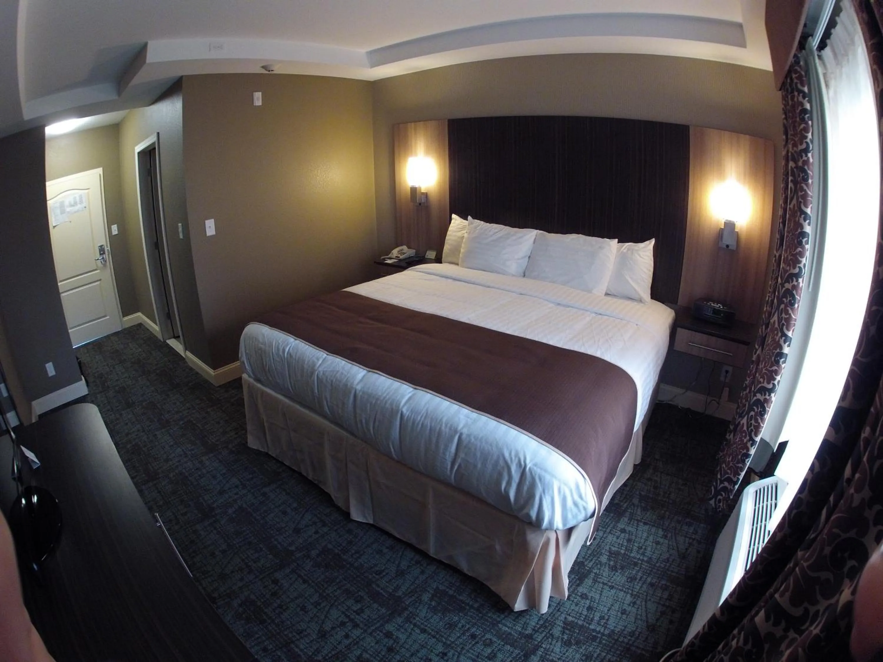 Photo of the whole room, Bed in Aashram Hotel by Niagara River