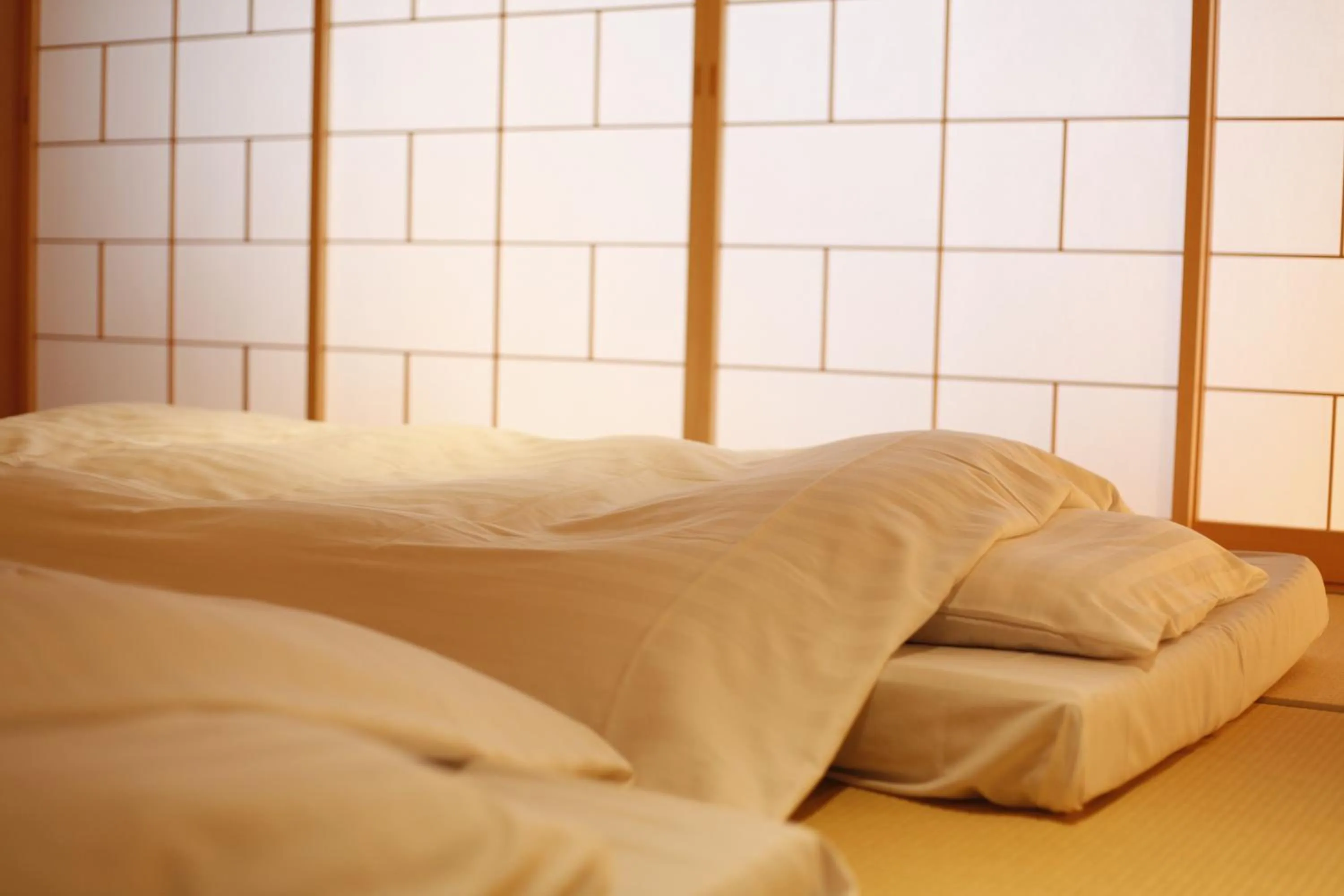 Bed in Yuraku Kinosaki Spa & Gardens