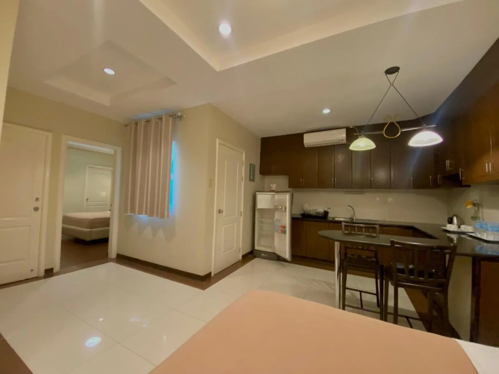 Kitchen or kitchenette, Bed in Prism Hotel