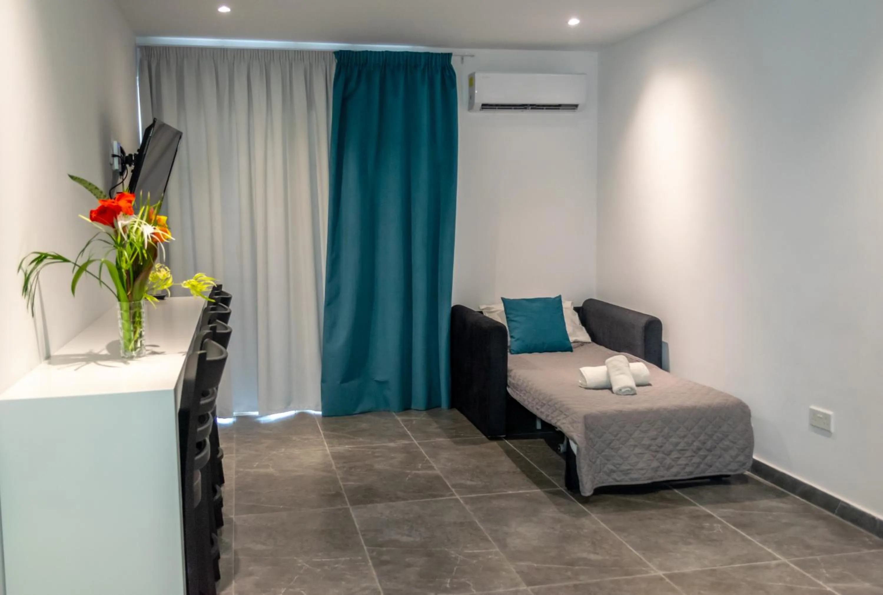 Living room, Bed in A Maos Hotel Apartments