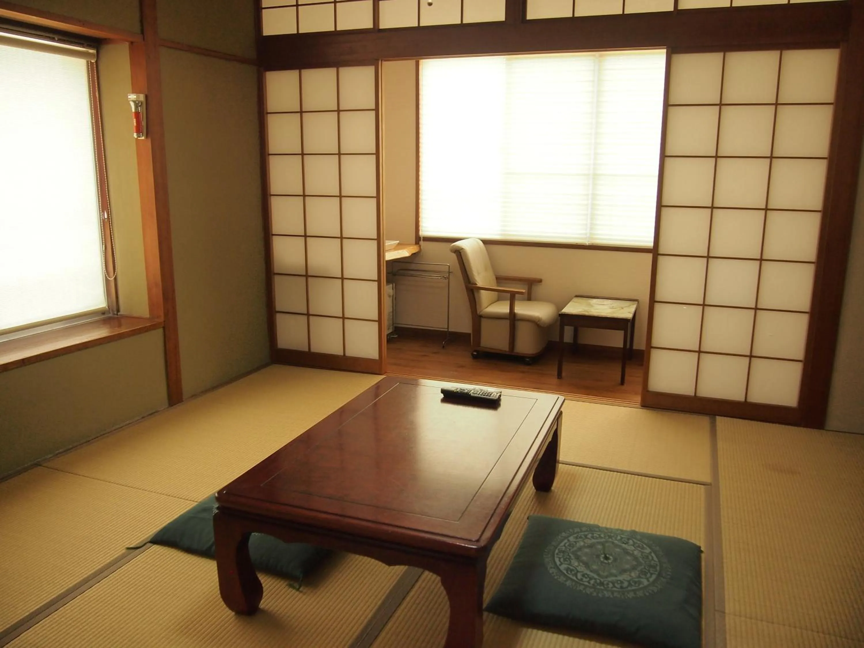 Seating area in Family Ryokan Kawakyu with Showa Retro, private hot spring