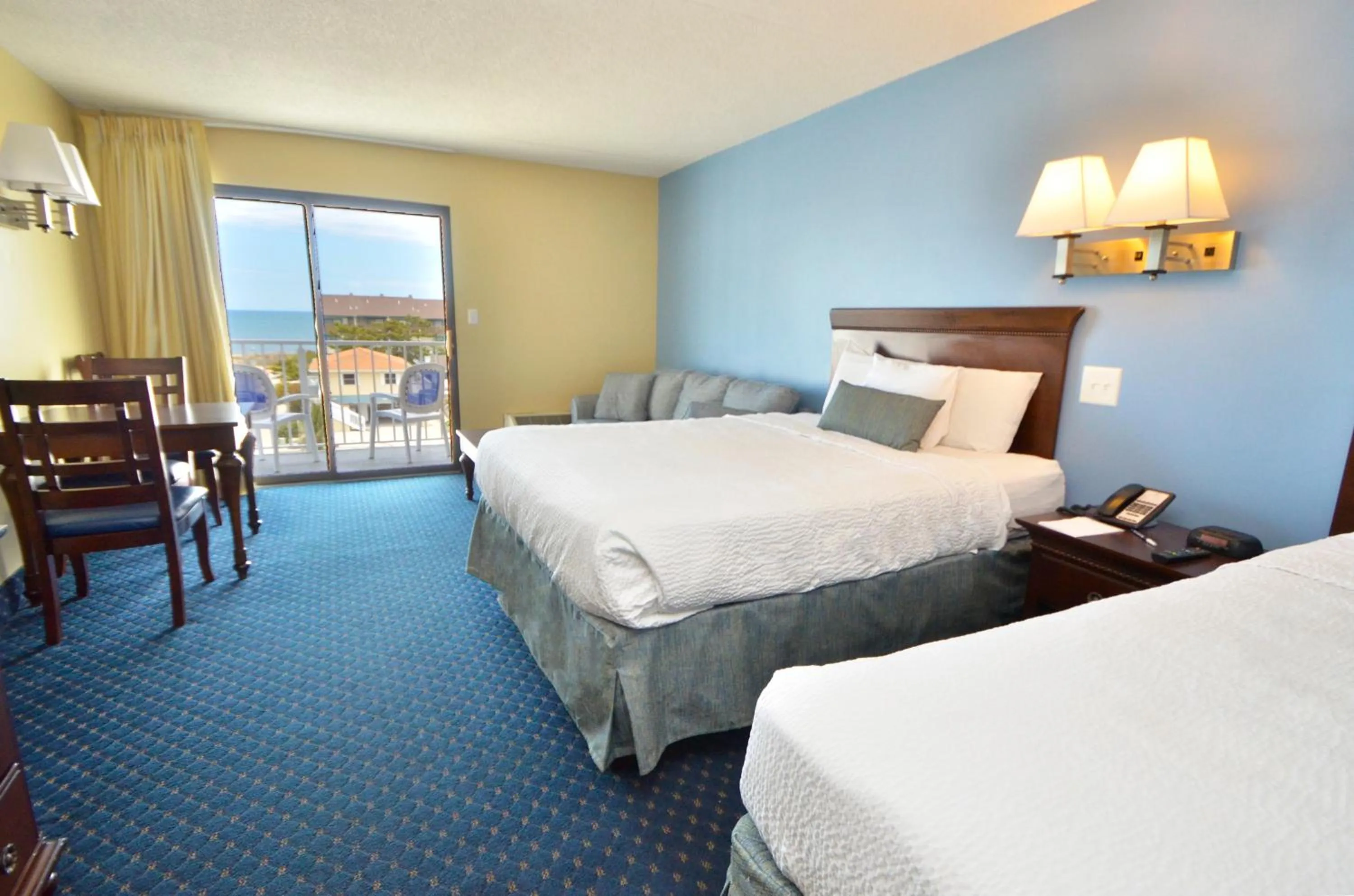 Bed in Coastal Palms Inn and Suites