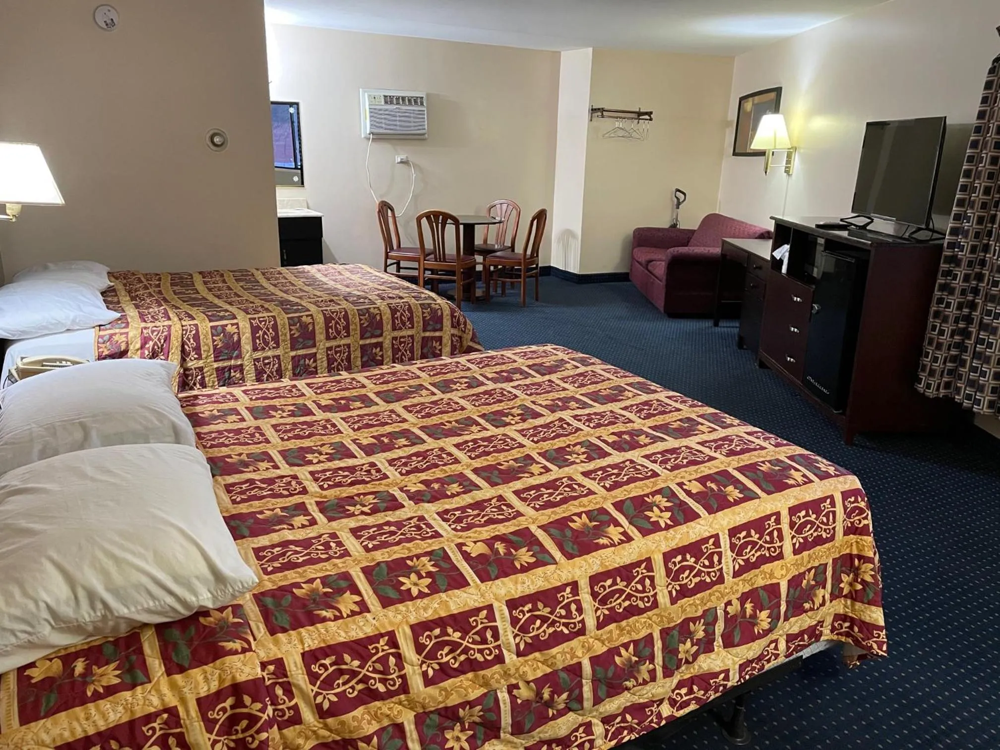 Bed in American Inn and Suites