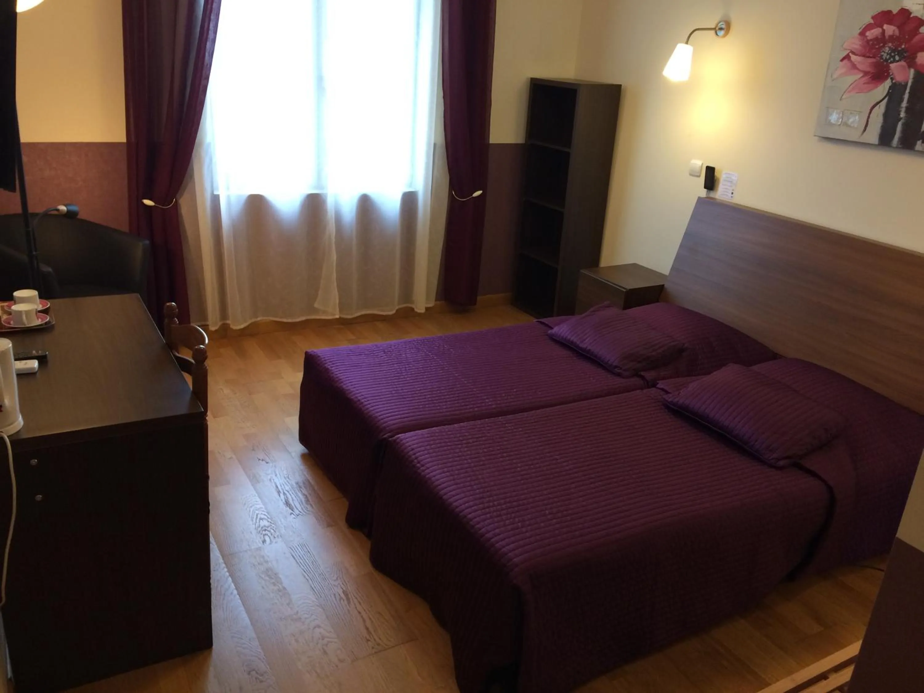 Bed in LOGIS Hôtel Le Chantoiseau