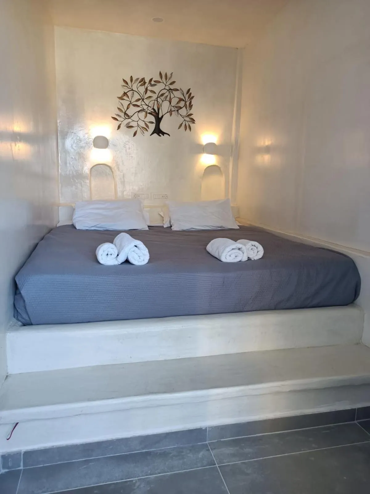 Bed in The Muses of Santorini Private Jacuzzi Suites