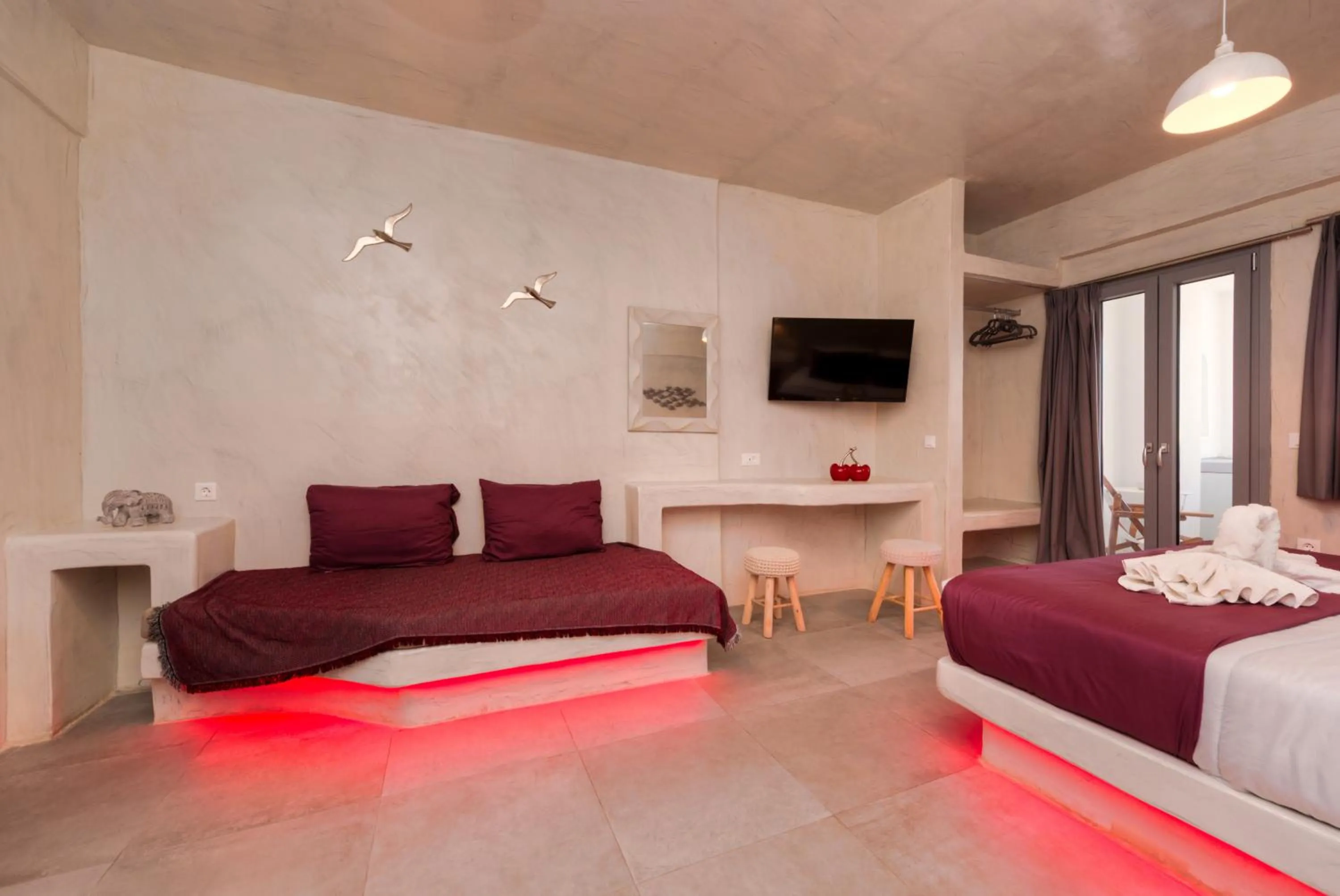Living room, Bed in The Muses of Santorini Private Jacuzzi Suites