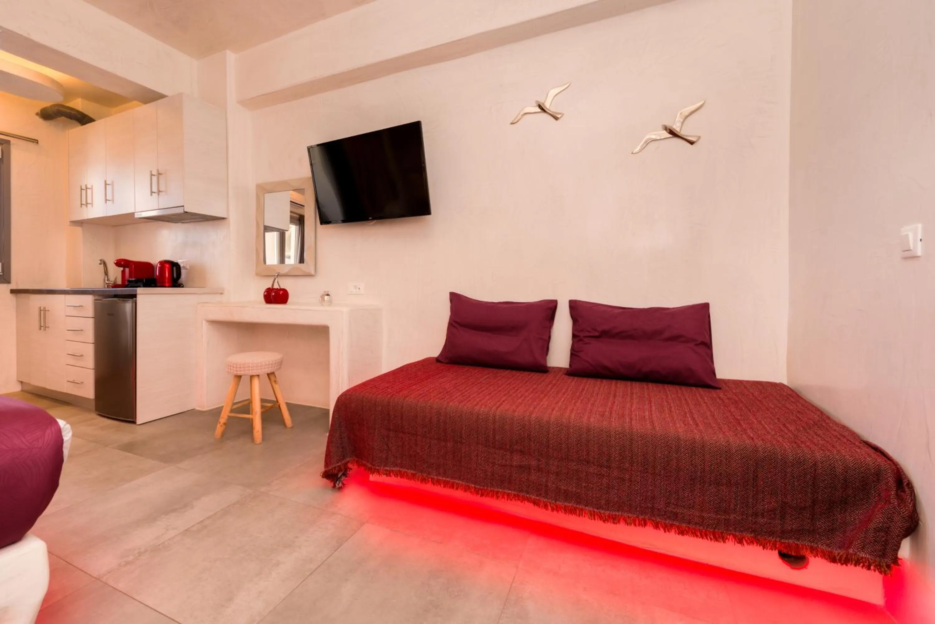 Seating area, Bed in The Muses of Santorini Private Jacuzzi Suites