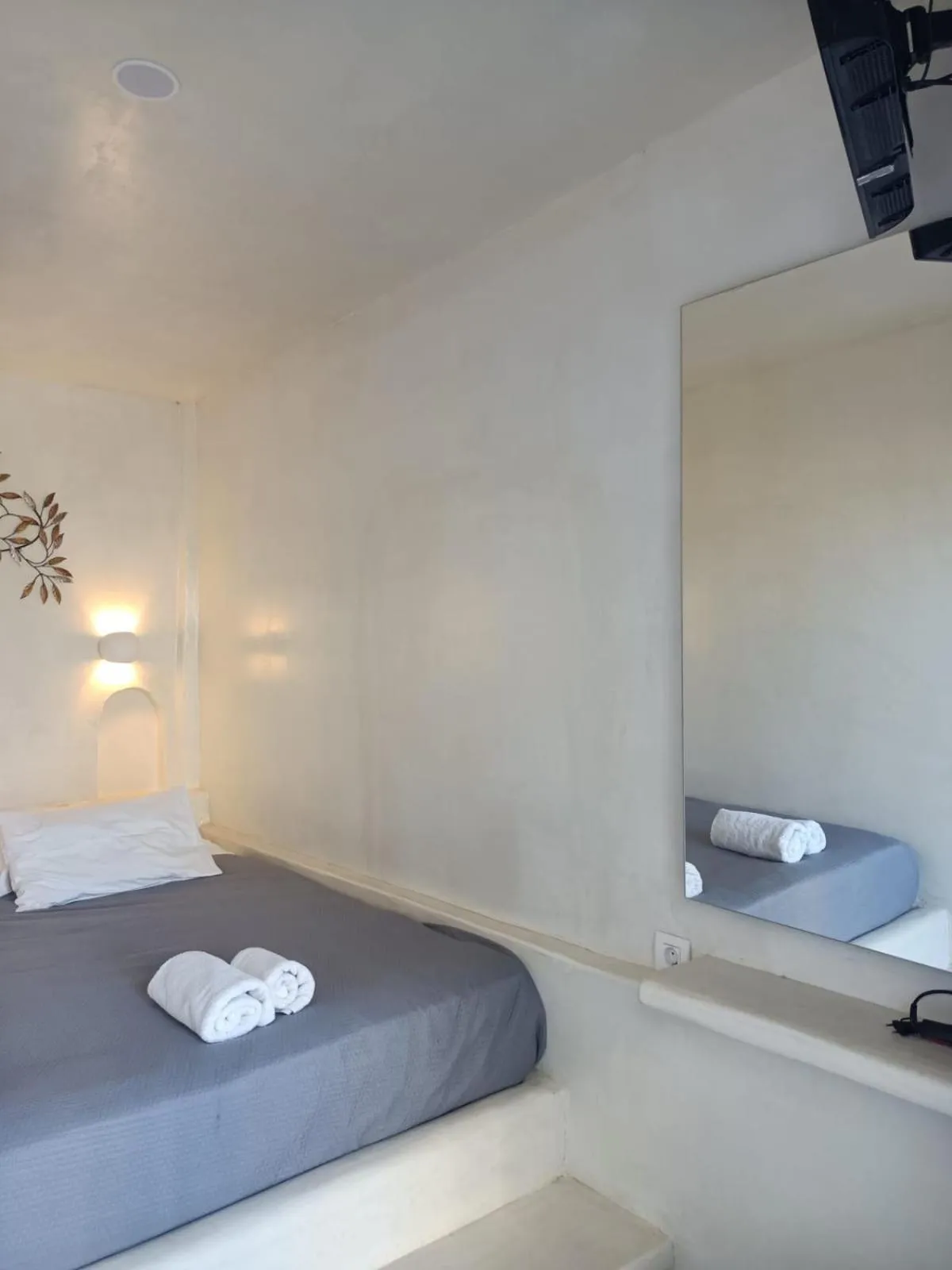 Bed in The Muses of Santorini Private Jacuzzi Suites