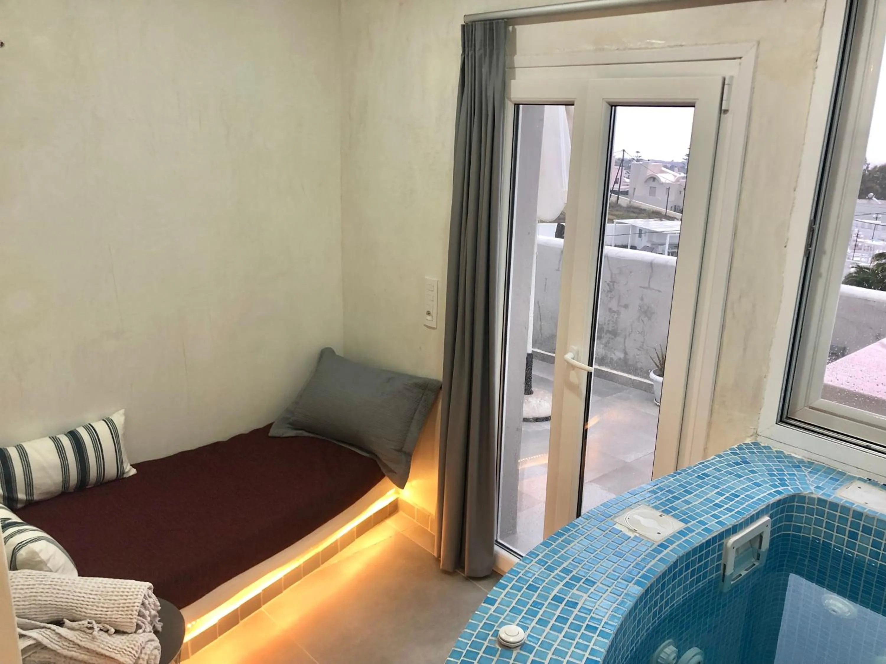 Seating area, Bed in The Muses of Santorini Private Jacuzzi Suites