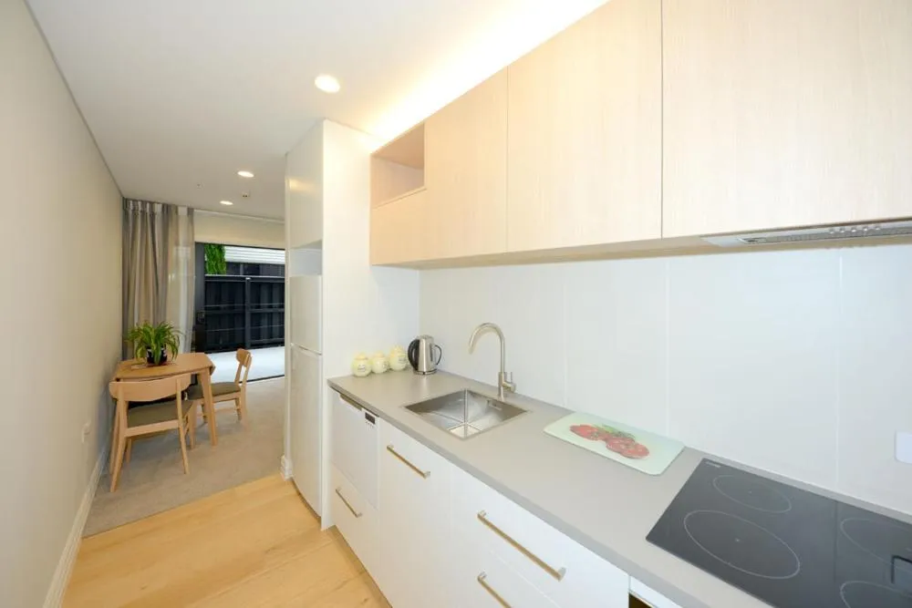Kitchen or kitchenette in West Fitzroy Apartments