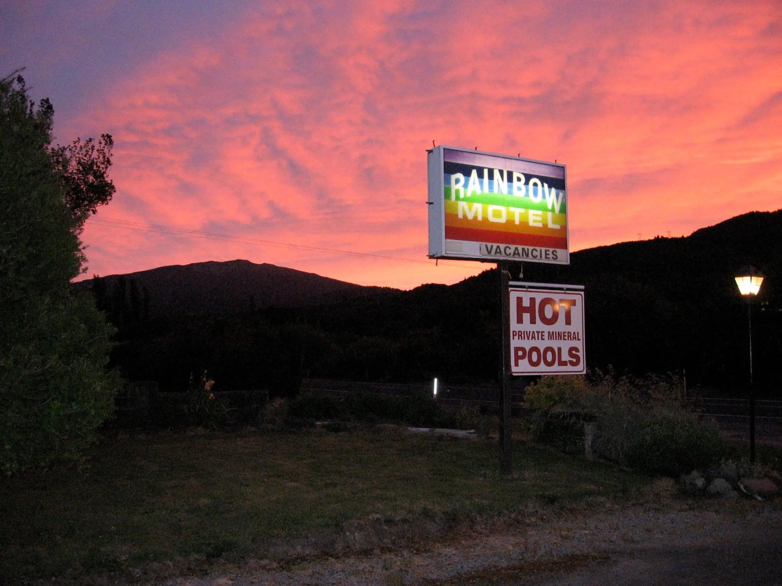 Property logo or sign in Rainbow Motel & Hot Pools