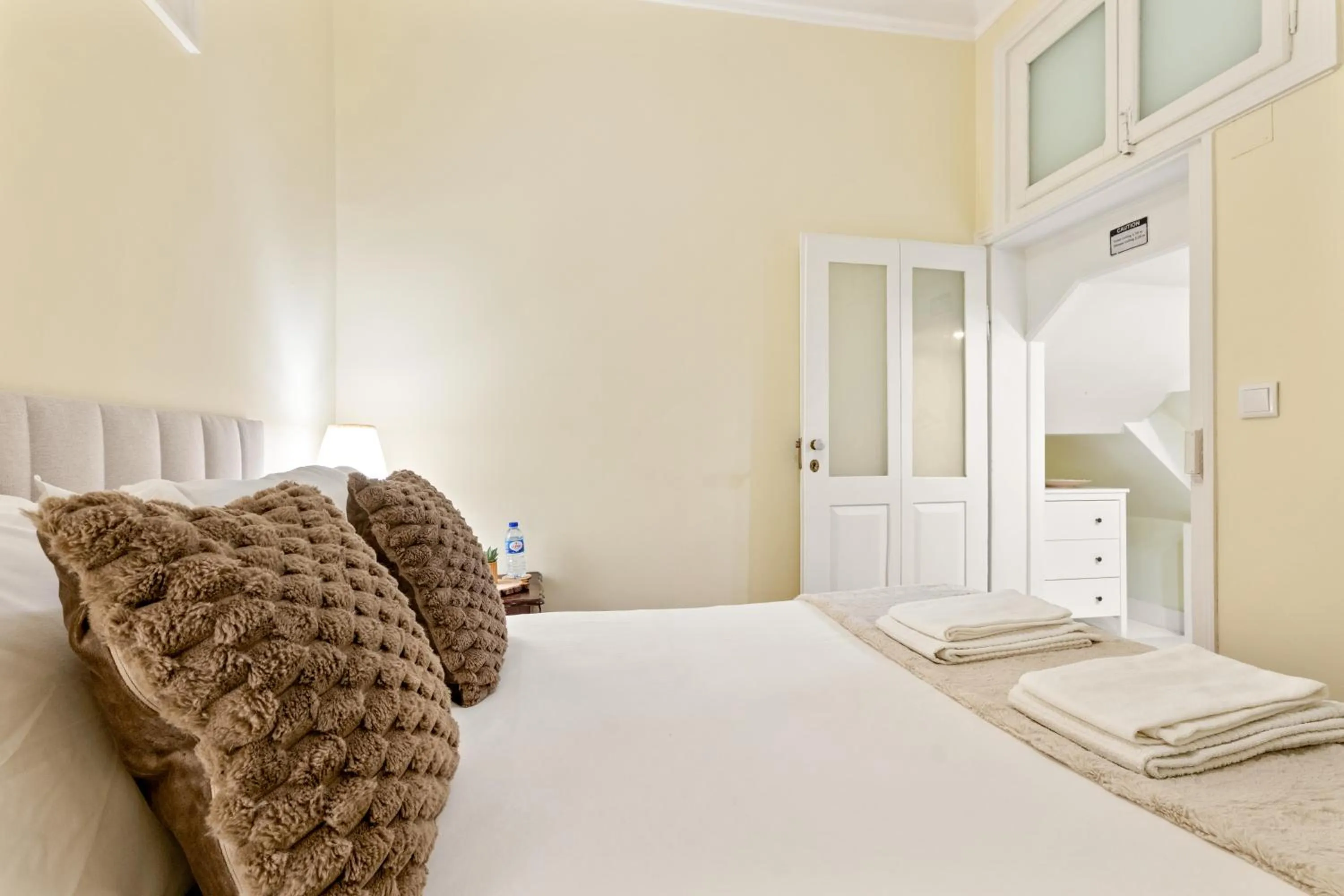 Bed in 1898 Home & Suites