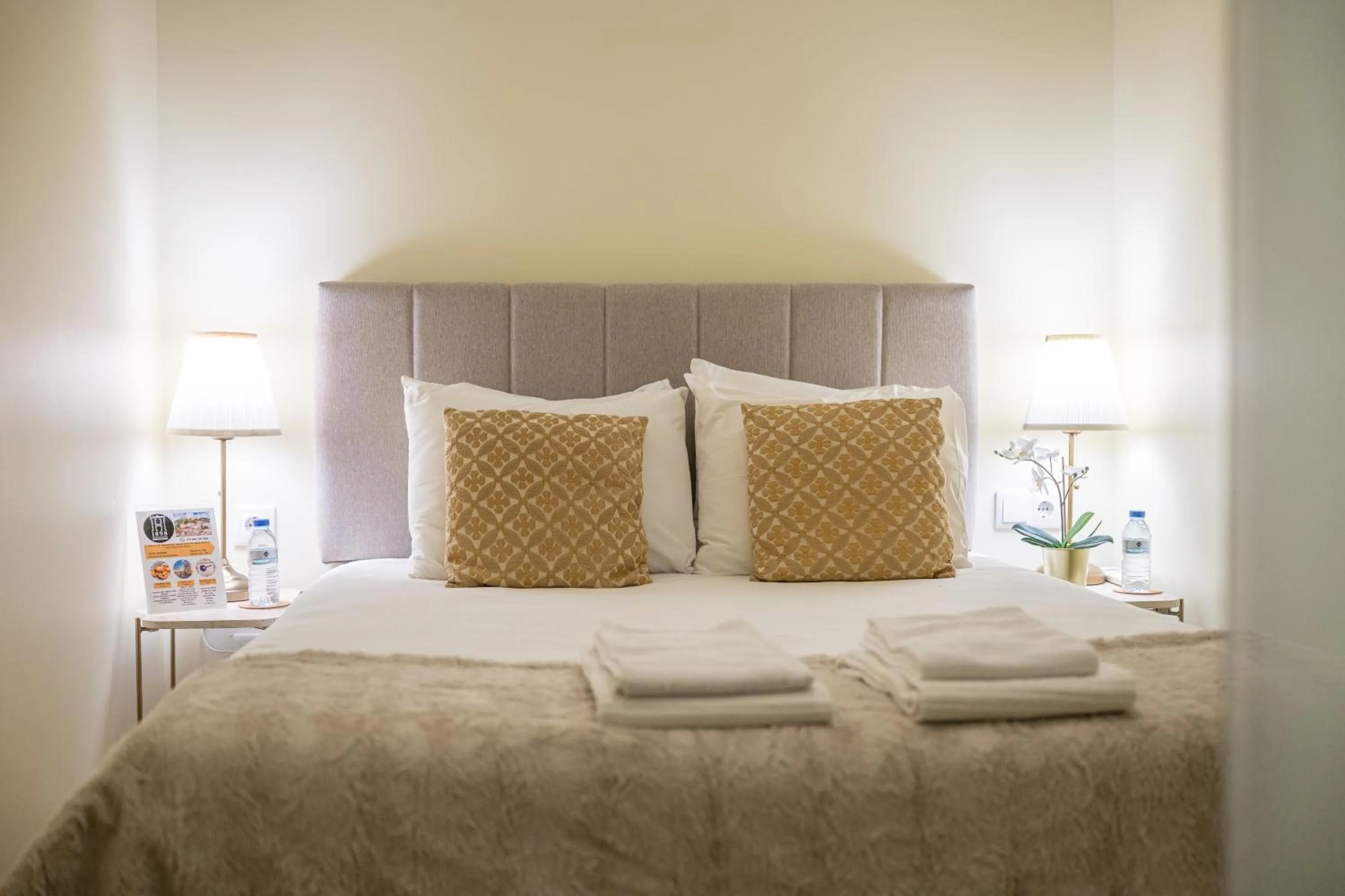 Bed in 1898 Home & Suites