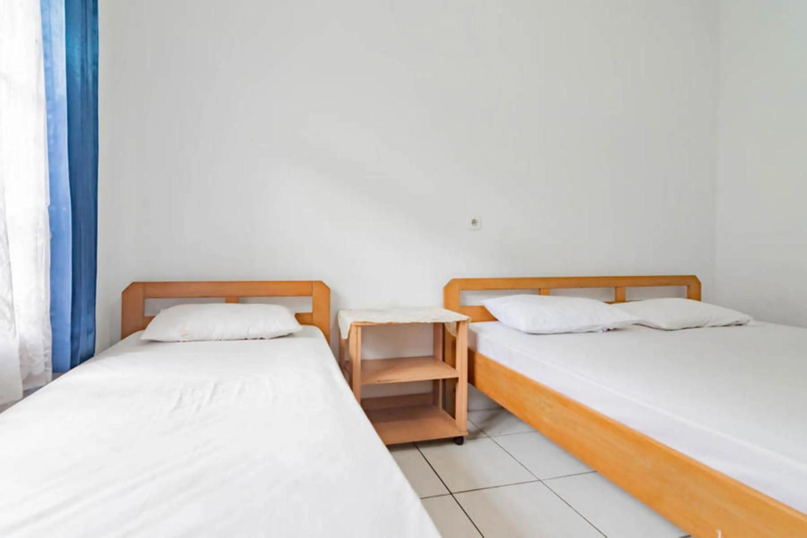 Bed in Pall Inn Puncak Mitra RedDoorz