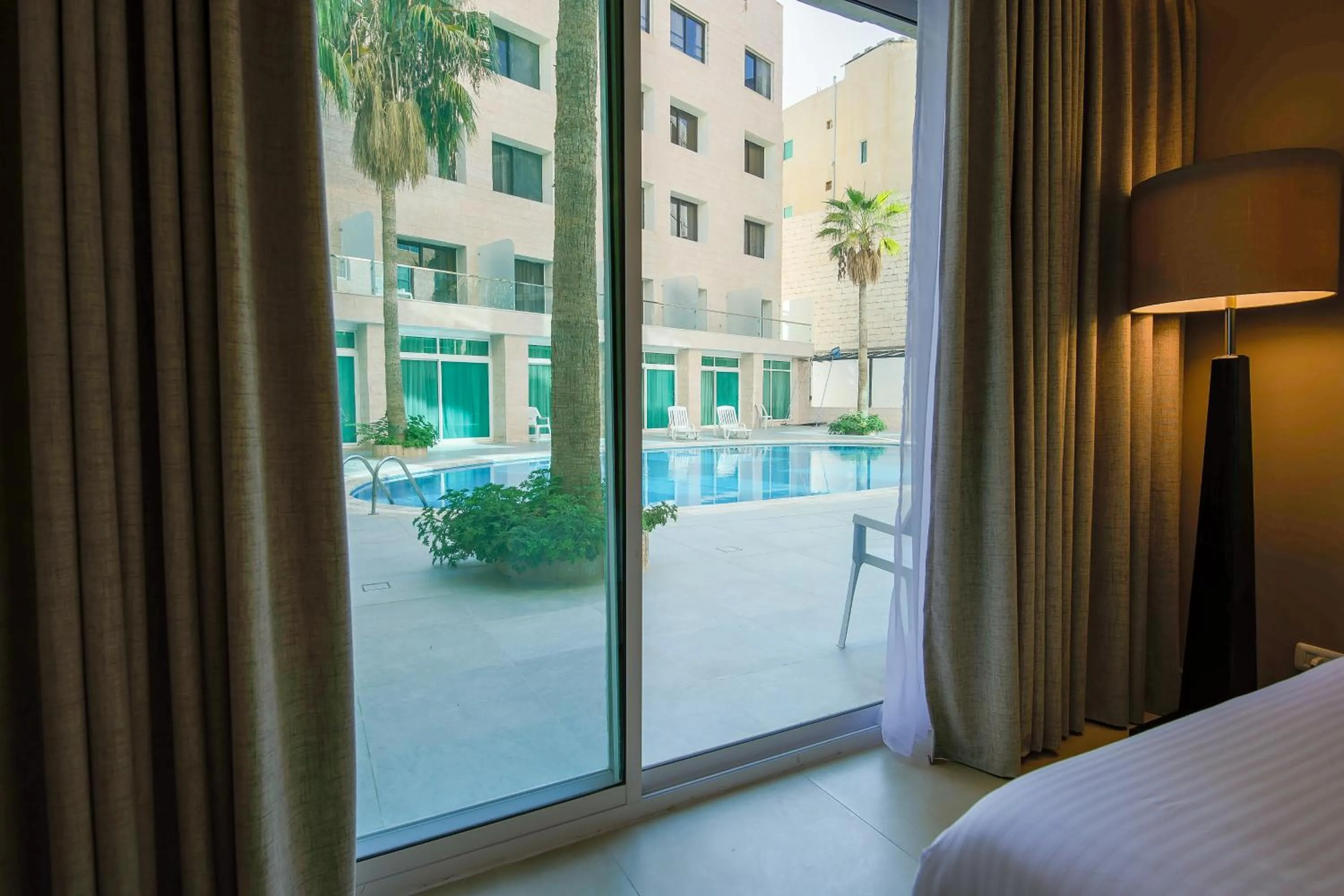Pool view, Bed in Petra Palace Hotel