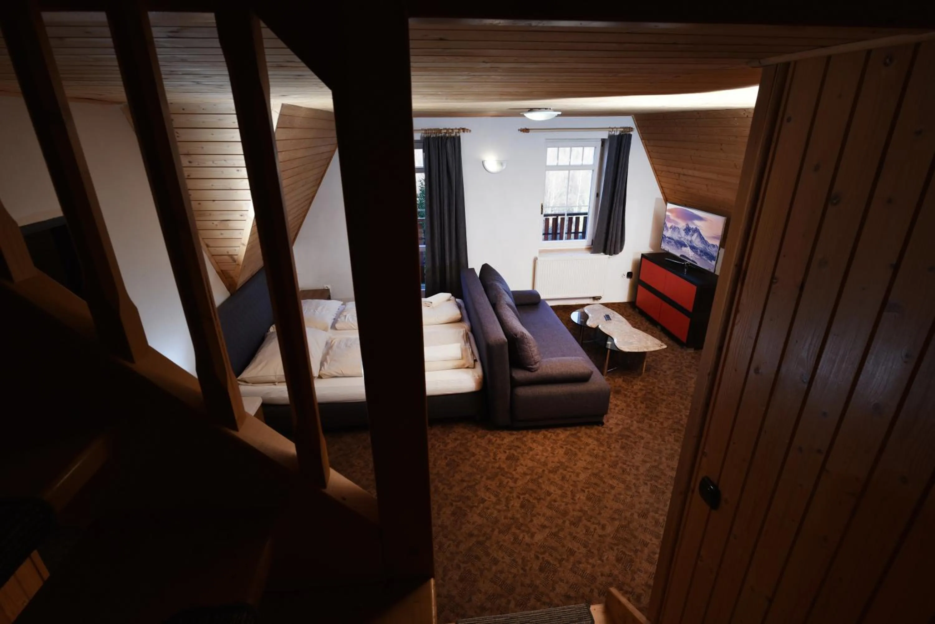 Communal lounge/ TV room, Bed in Penzión Valaška