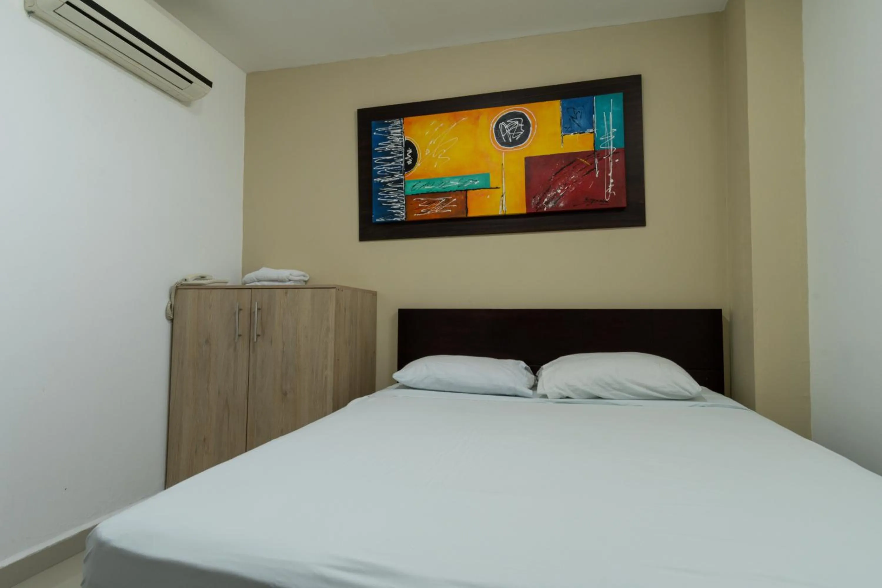 Bed in Genesis Hotel