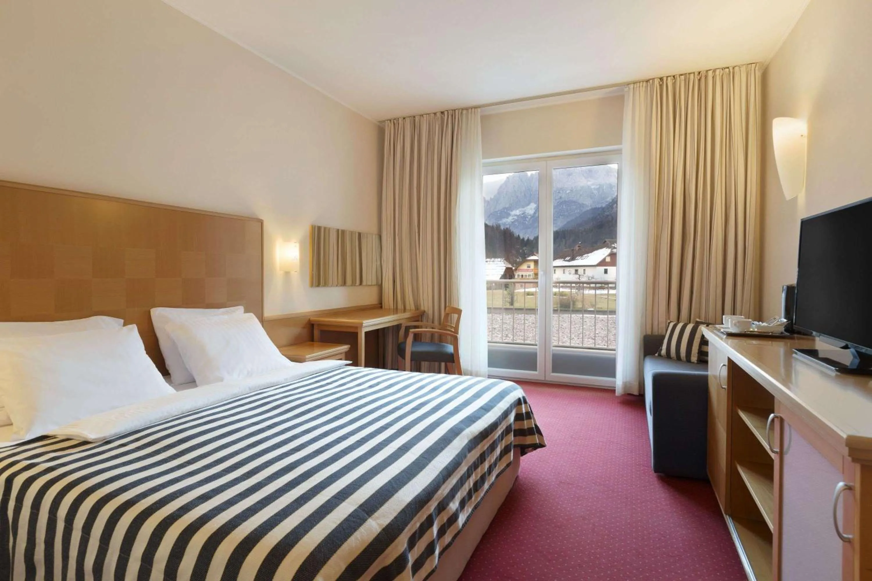 Photo of the whole room, Bed in Ramada Hotel & Suites Kranjska Gora