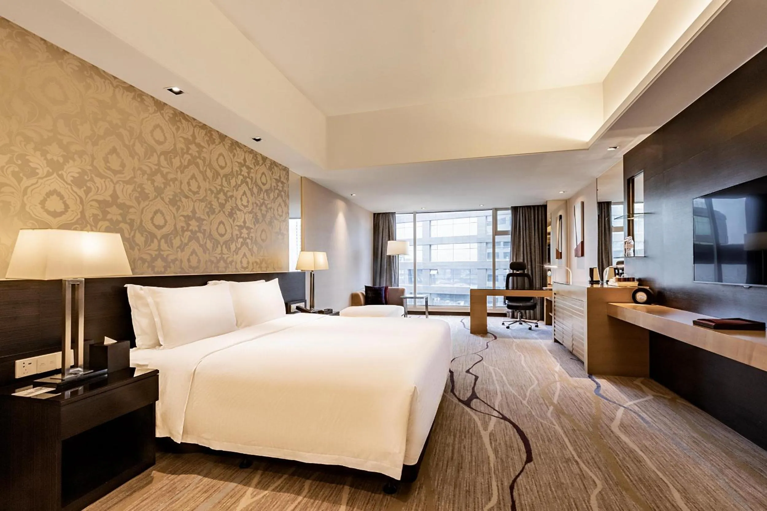 Communal lounge/ TV room, Bed in Swiss Grand Xiamen