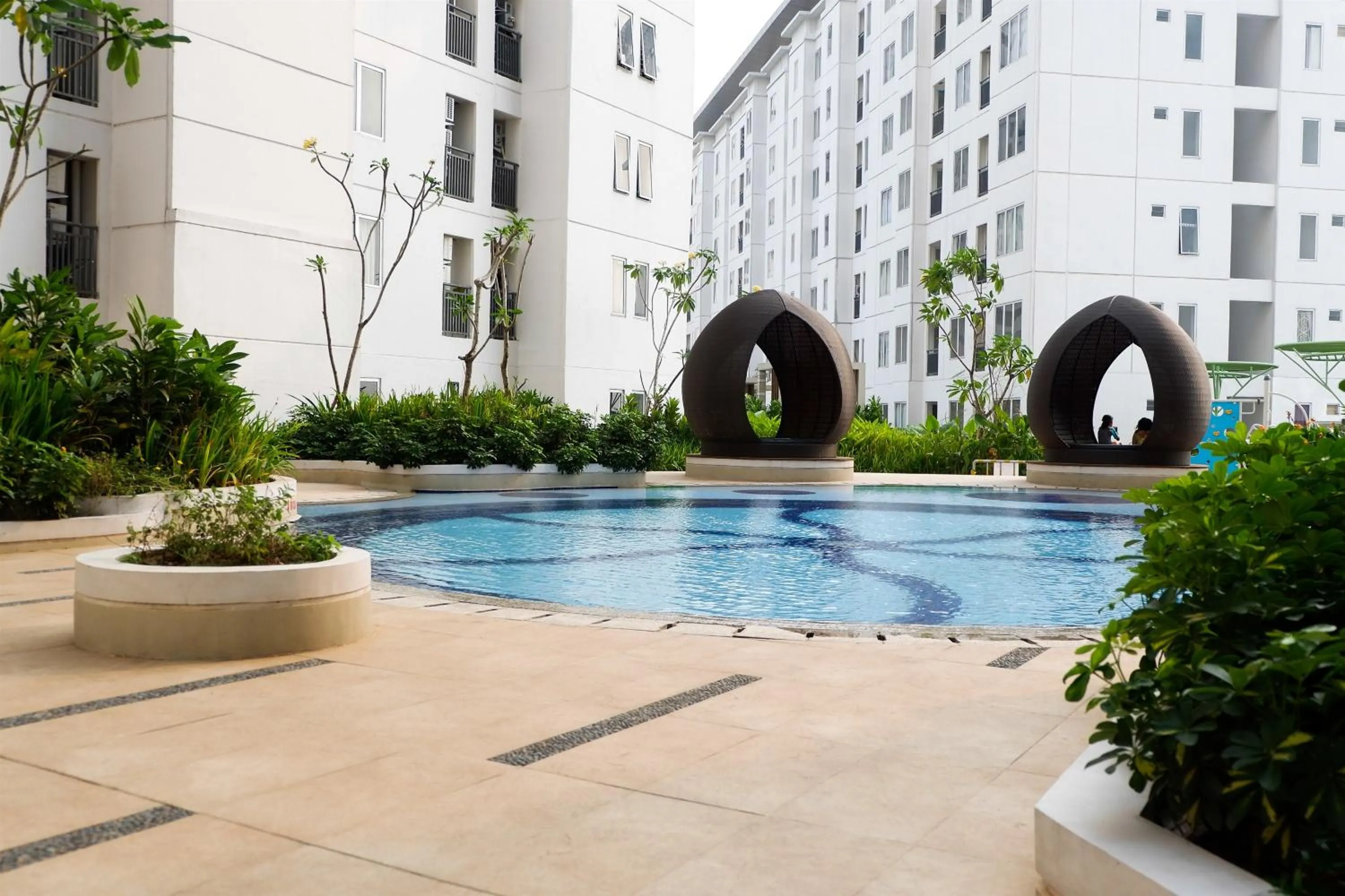Swimming pool in Exquisite 2BR Bassura City Apartment near Shopping Mall By Travelio