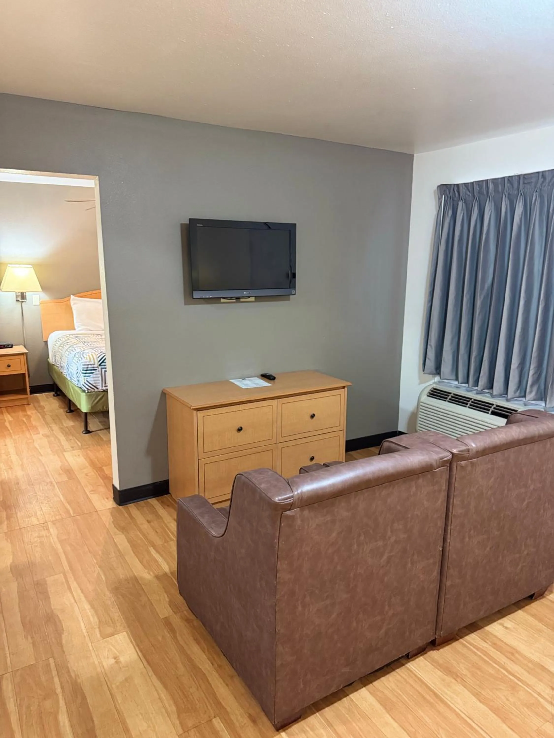 Seating area, Bed in Blue Bonnet Suites -Lubbock, TX - Medical Center