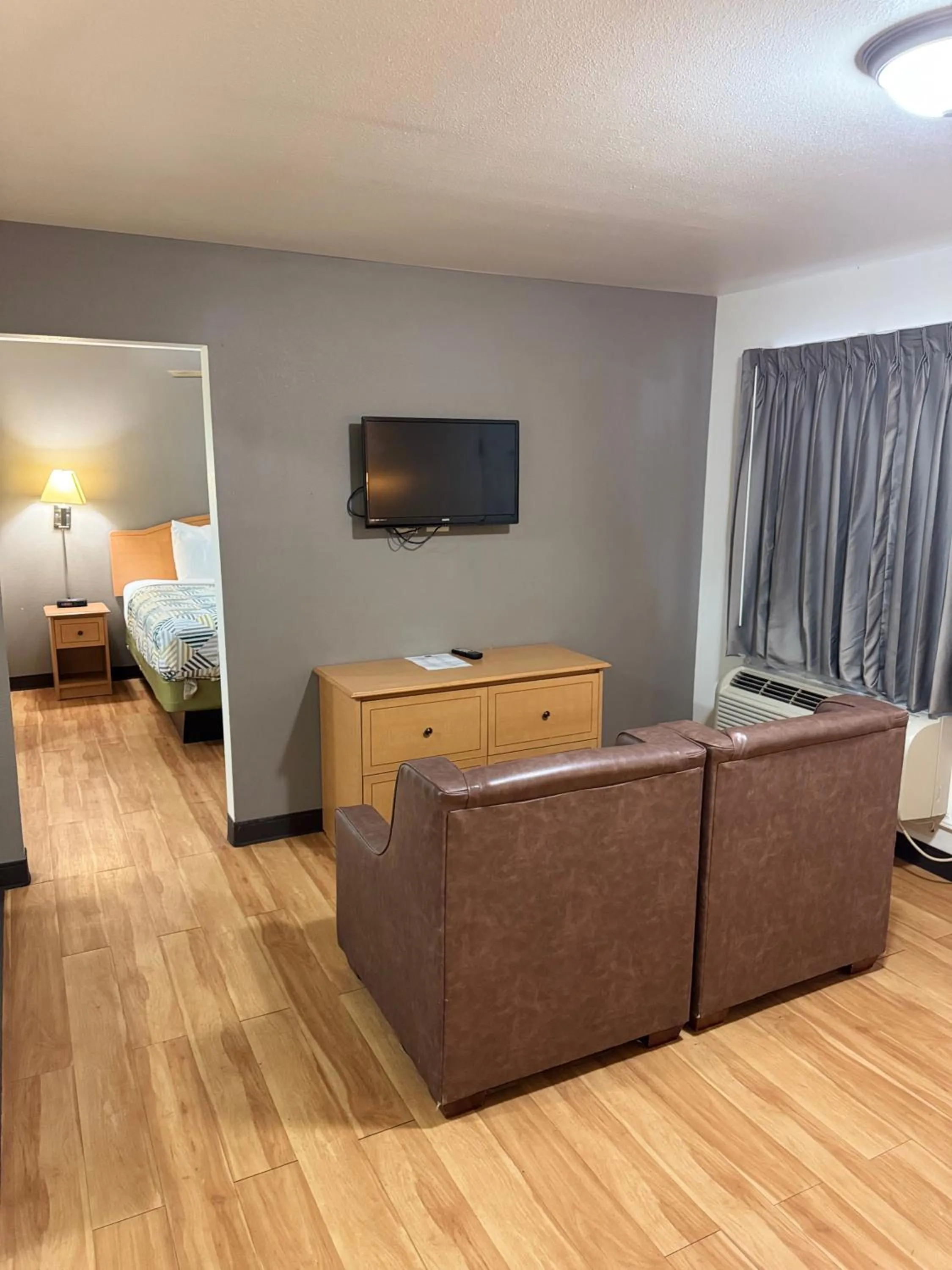 Seating area, Bed in Blue Bonnet Suites -Lubbock, TX - Medical Center