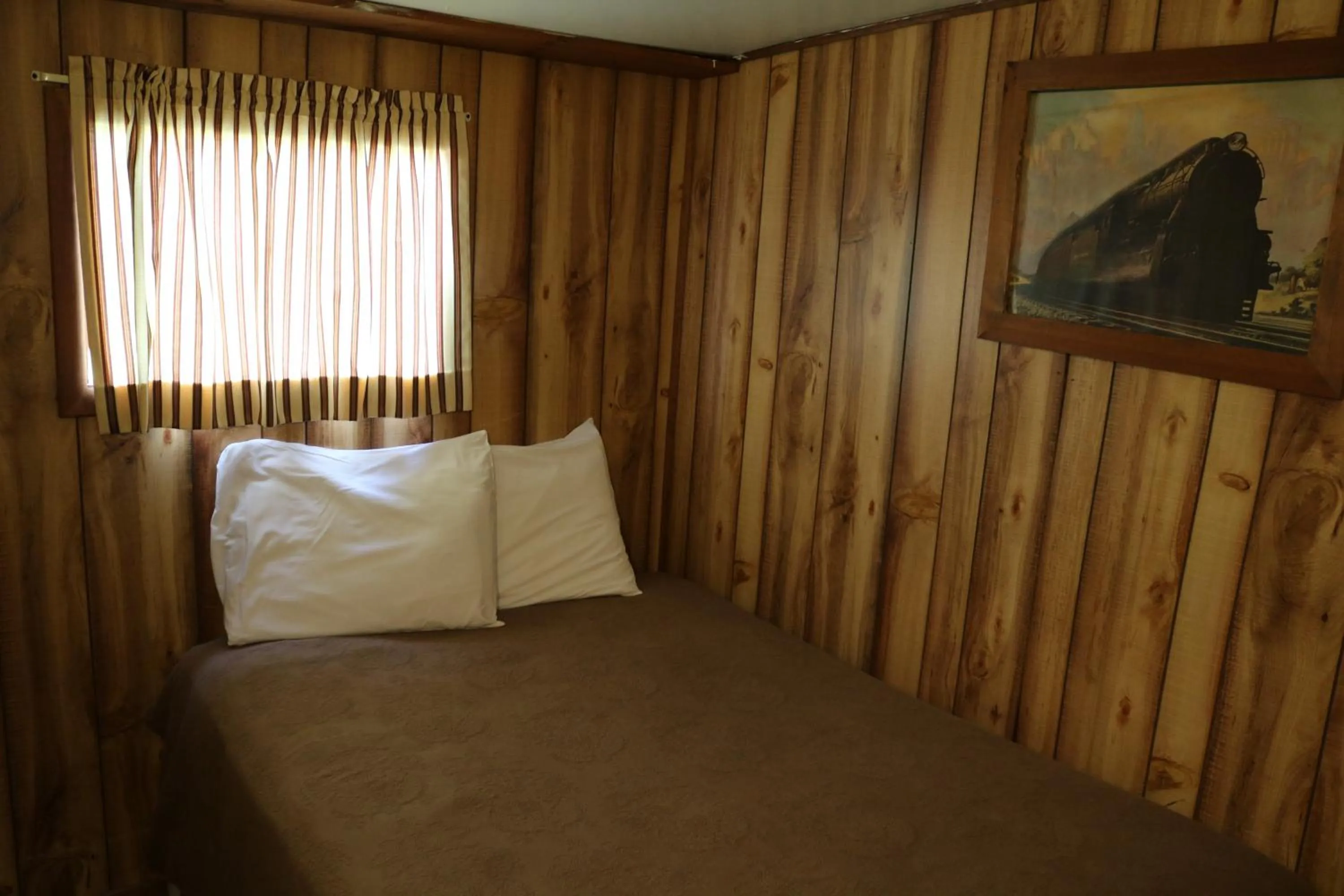 Bed in Red Caboose Motel & Restaurant